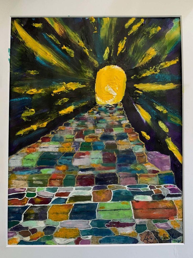 Path of colorful steps leading to a yellow light