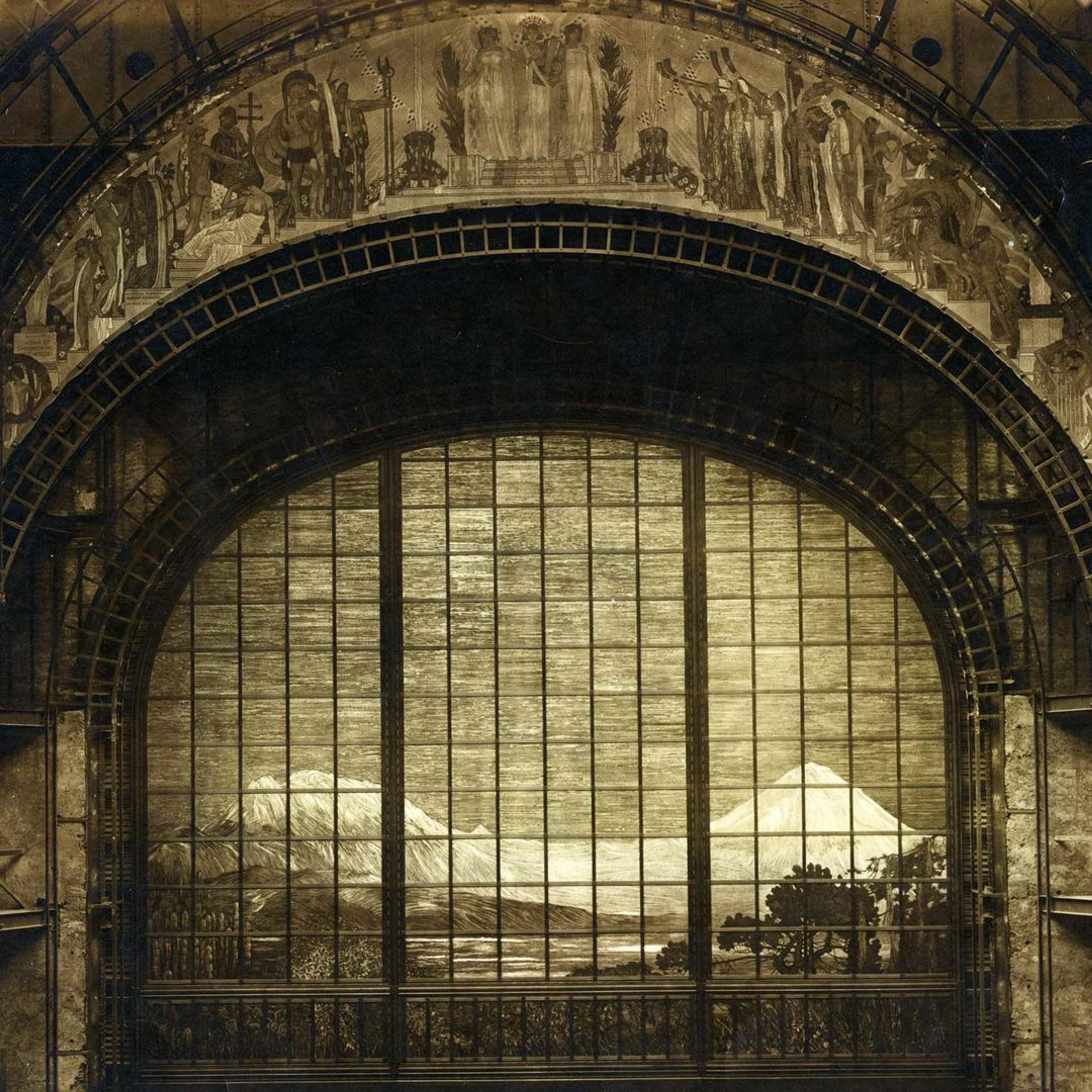 An arching mosaic curtain depicting snow-capped peaks behind fir trees and topped with a proscenium