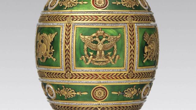 Ornately decorated green egg with gold detailing and intricate designs.