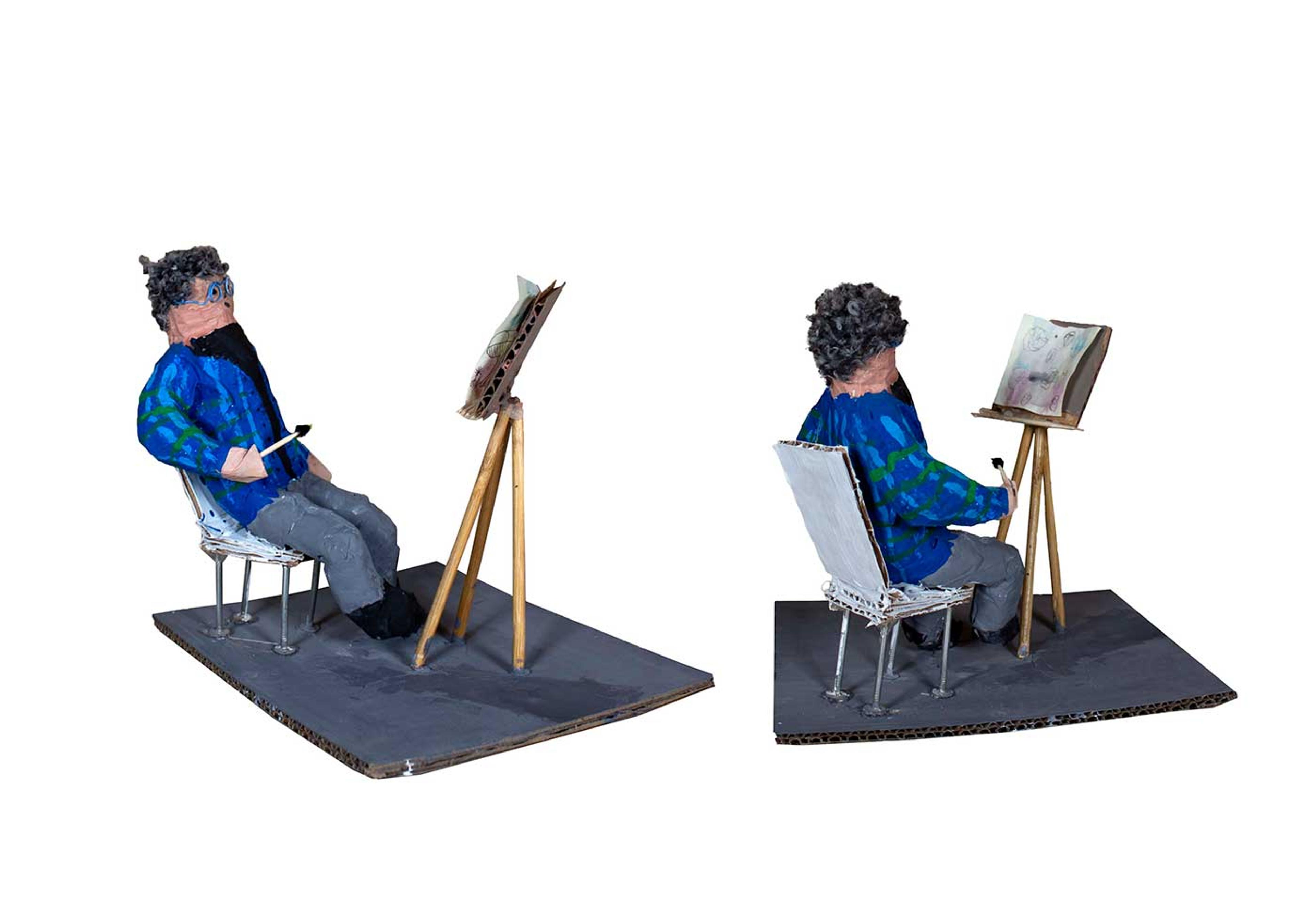 Papier mâché scultpure of a man sitting in front of an easel holding a paintbrush.