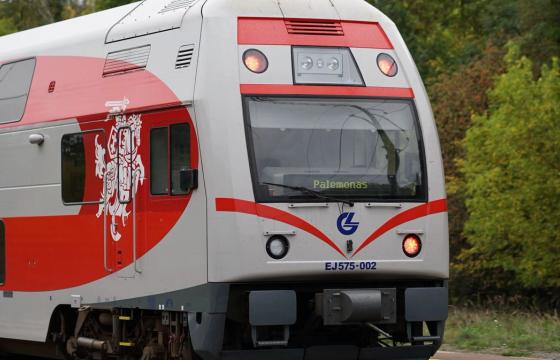 A modern Lithuanian train traveling through the countryside, captured in detail.