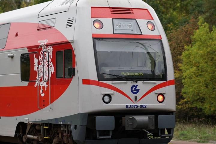 A modern Lithuanian train traveling through the countryside, captured in detail.