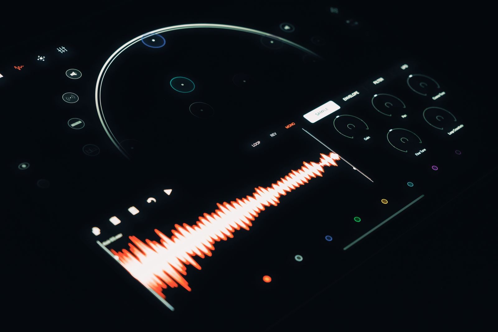 Close-up of a digital sound mixer screen displaying a bright orange audio waveform