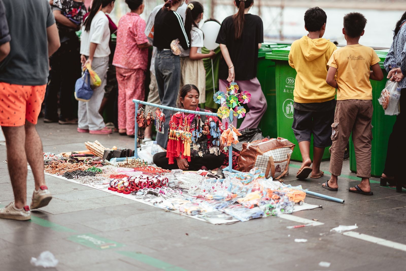A street vendor displays handcrafted goods for sale on a Phnom Penh pavement