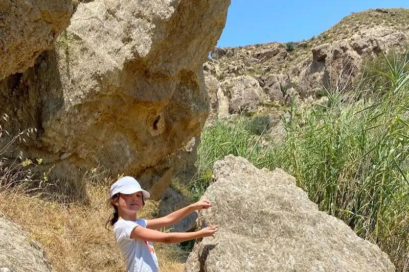 Walking to the source of the Rio Aguas - photo of girl in a hat on the route.