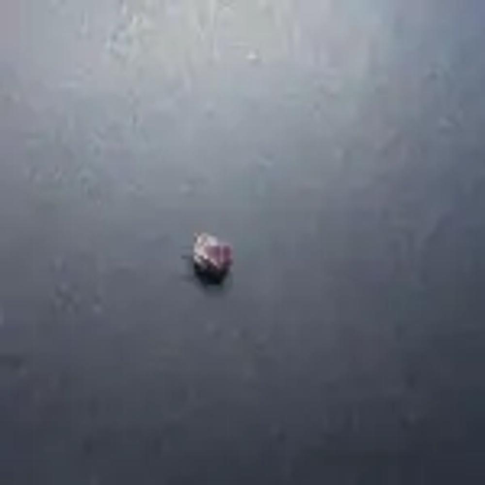 An unpolished garnet on a black background, photographed by me.