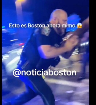 Video still of a Boston police officer doused with trash during an arrest