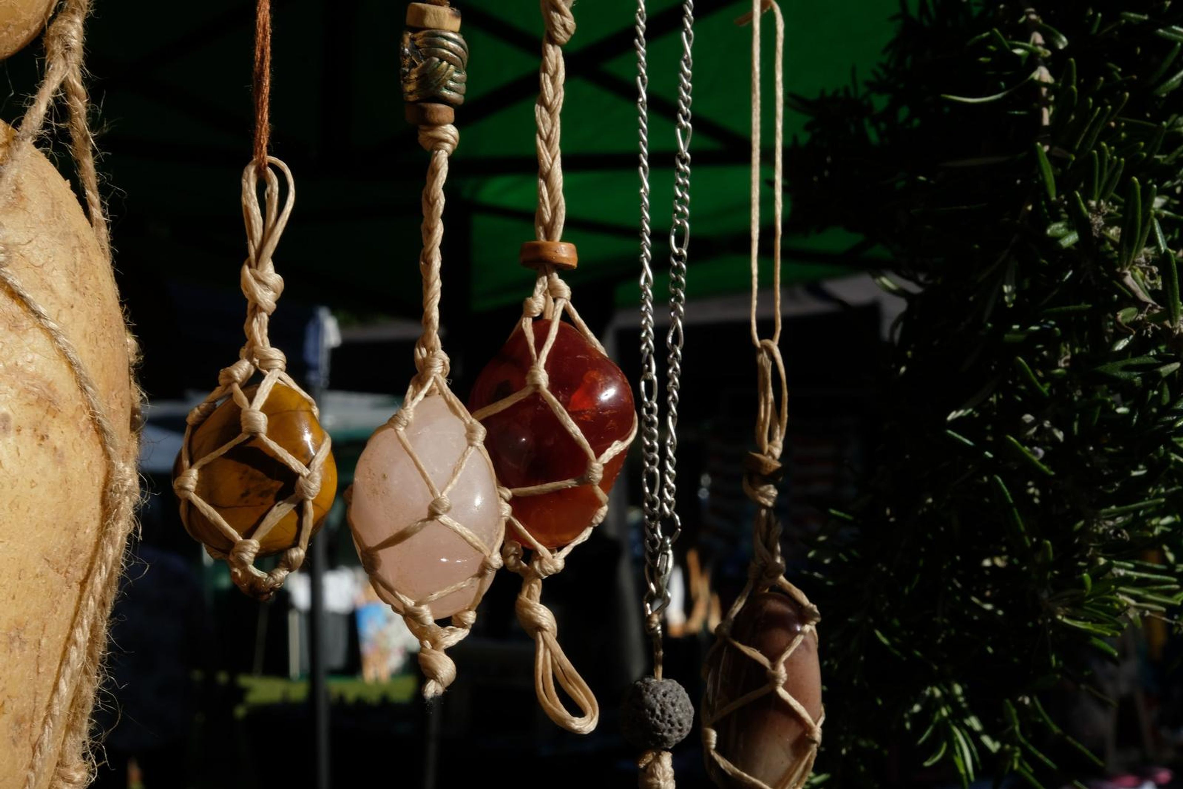 Wire-wrapped crystal pendants hanging from the stall canopy