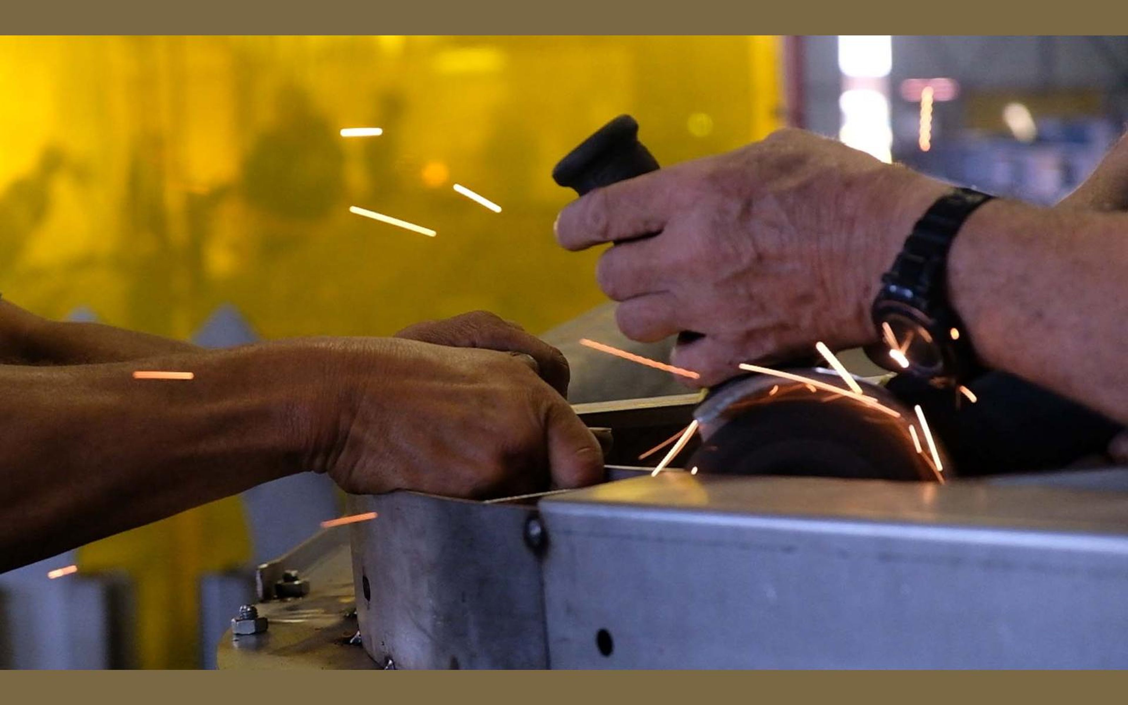 Team members working on a steel assembly