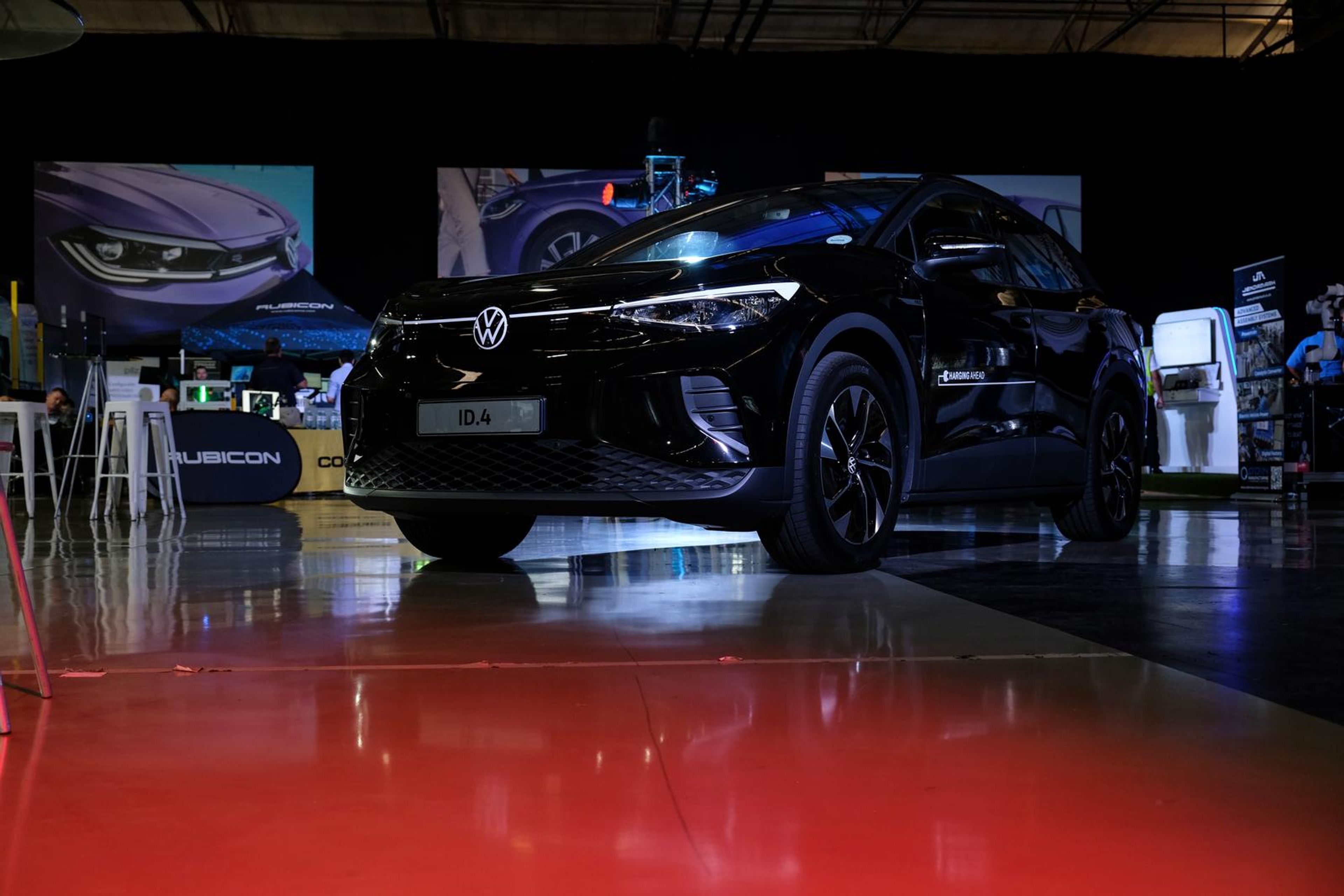 Black Volkswagen electric SUV on display on a red floor