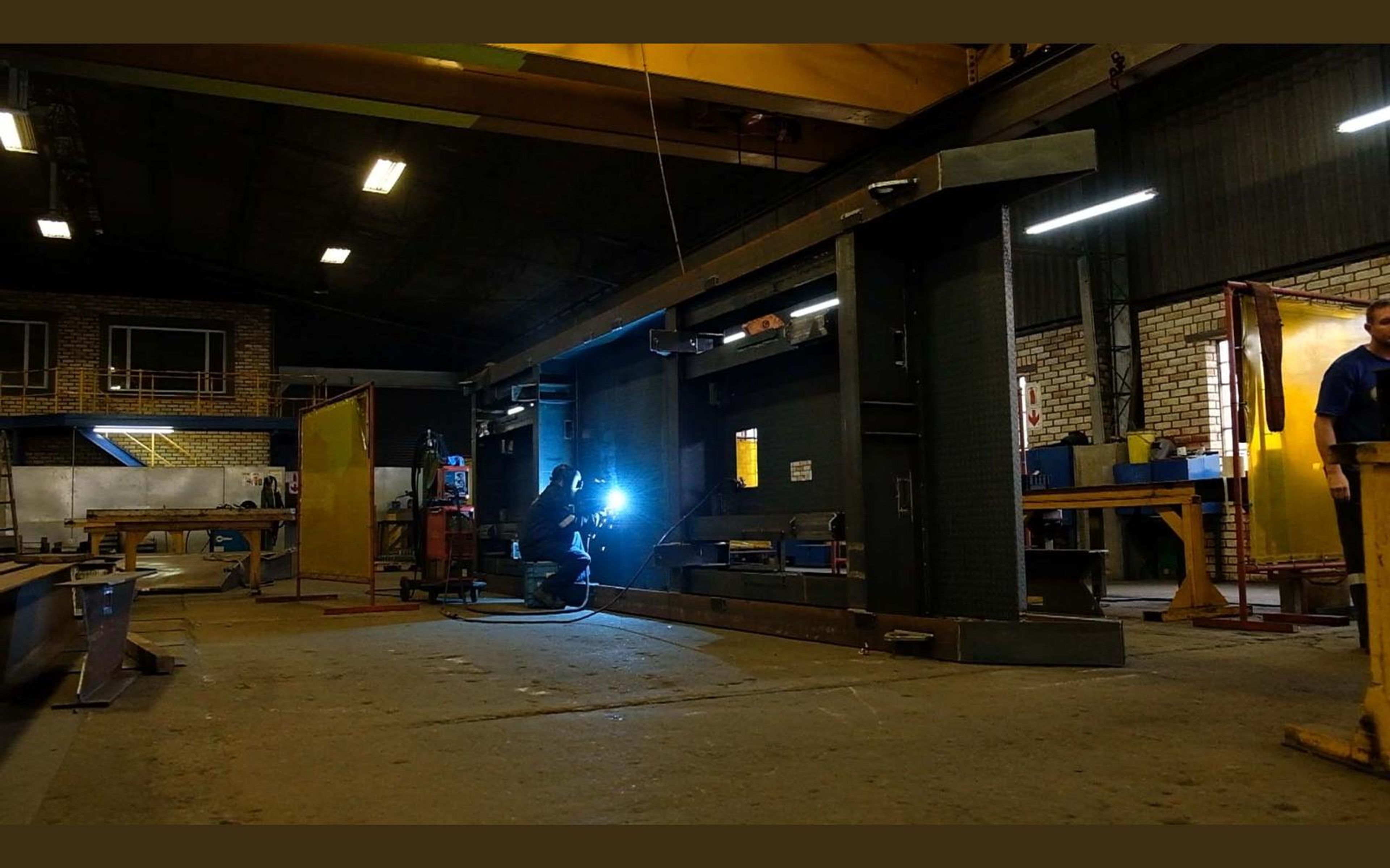 Overhead crane over steel frames in the fabrication bay