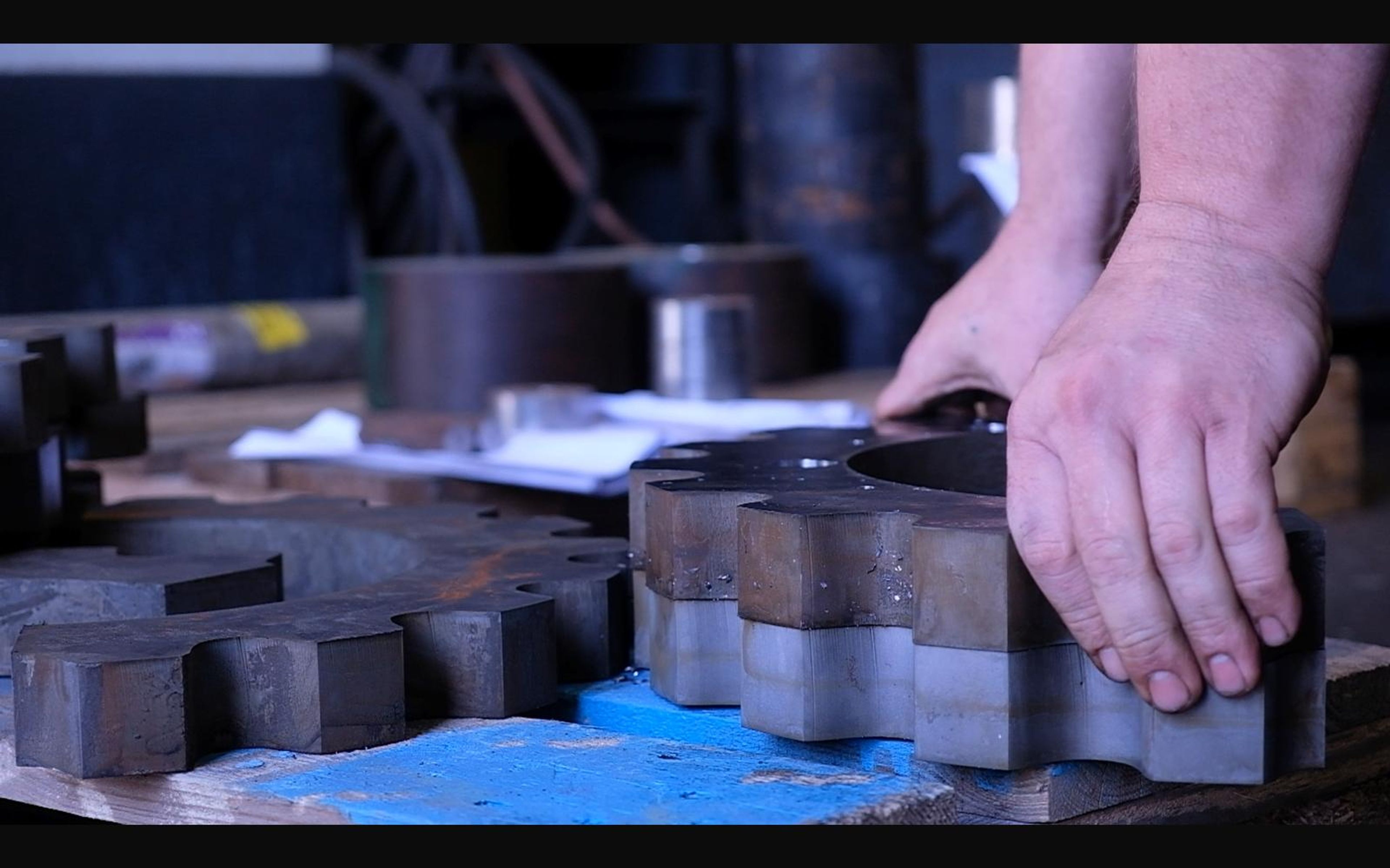 Hands sorting machined steel plates