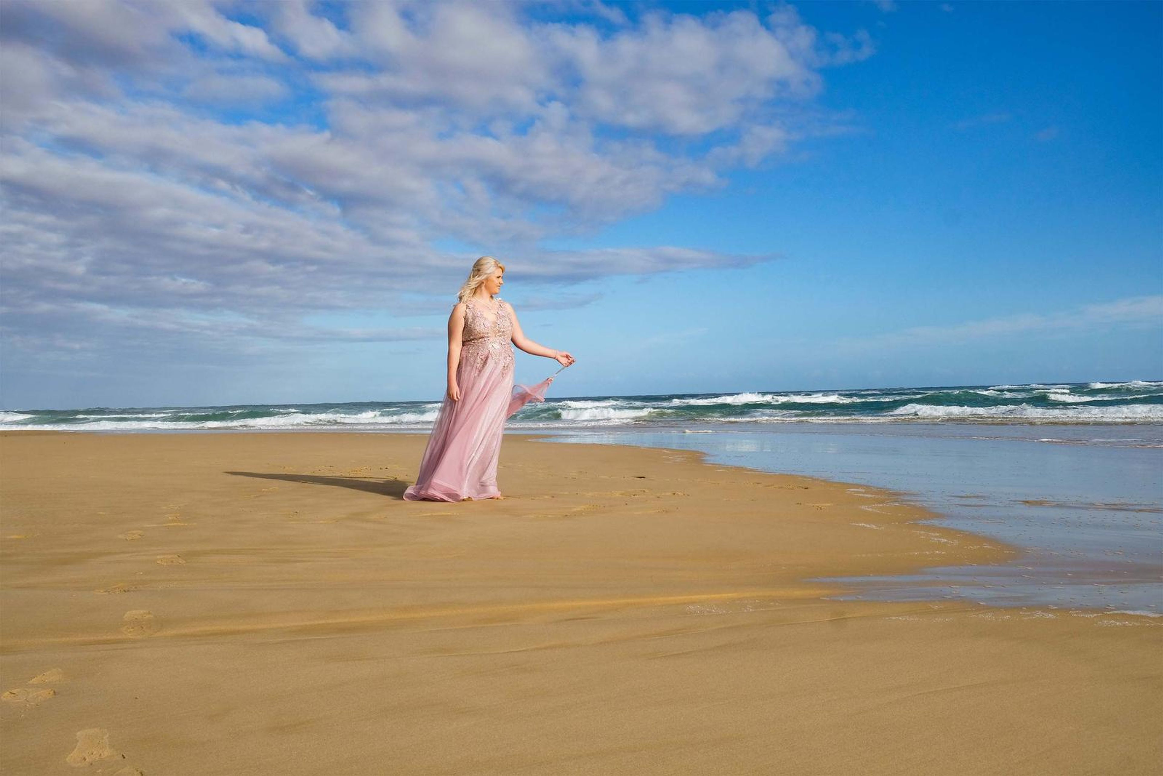 Standing on the shoreline with clouds overhead
