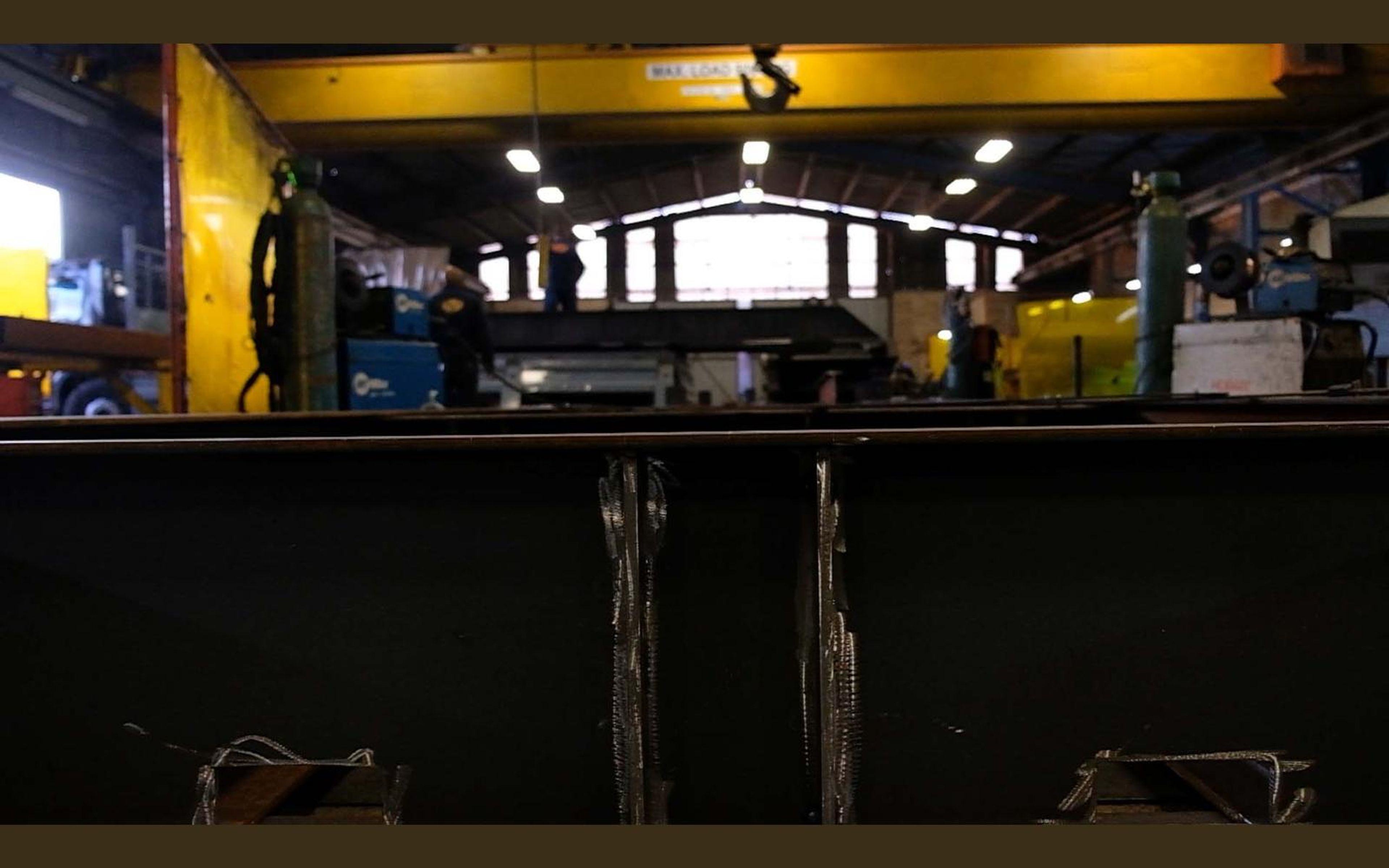 Wide view of the fabrication sector with steel frames on the floor