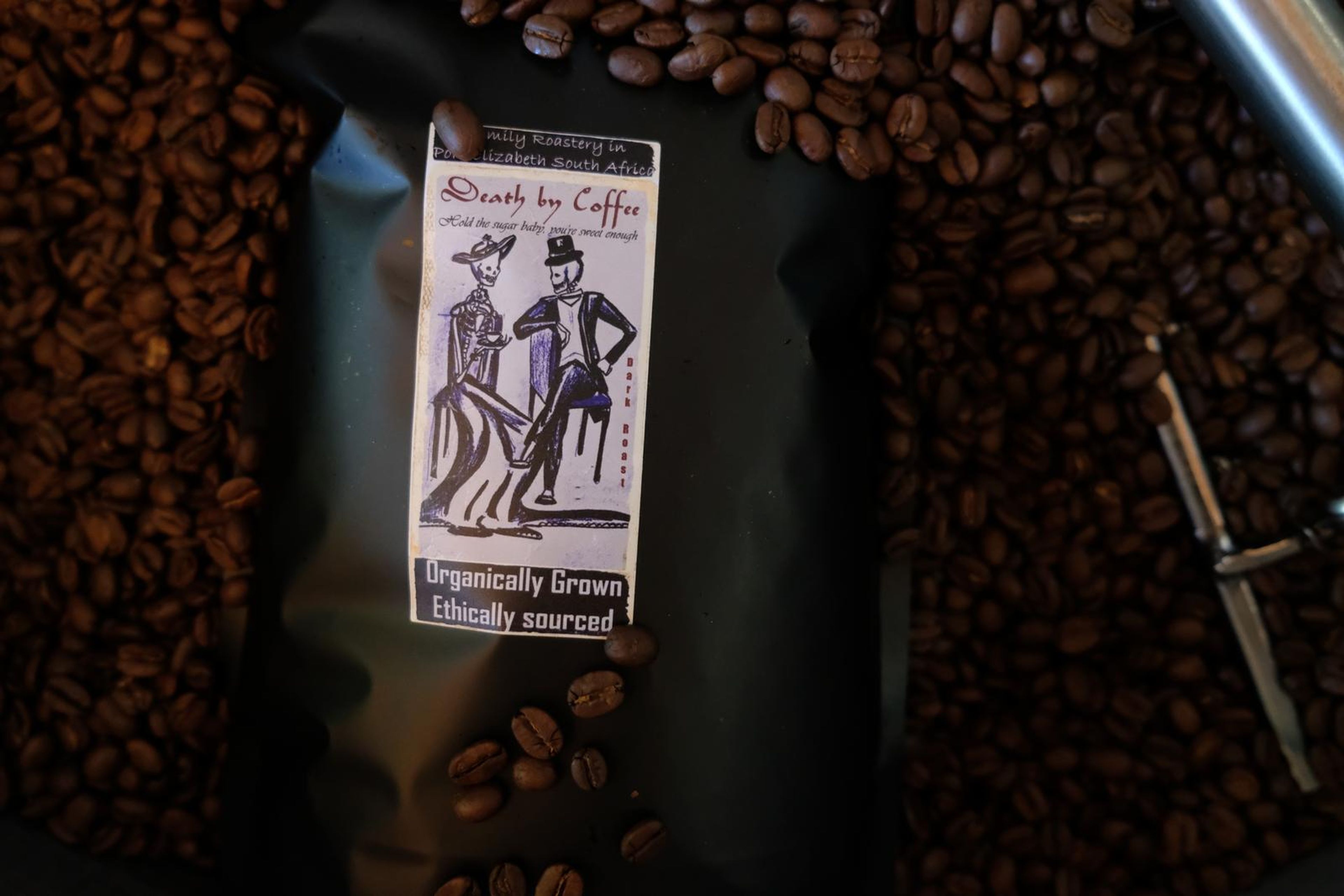 Death By Coffee creative product photography of coffee, beans and branded bags