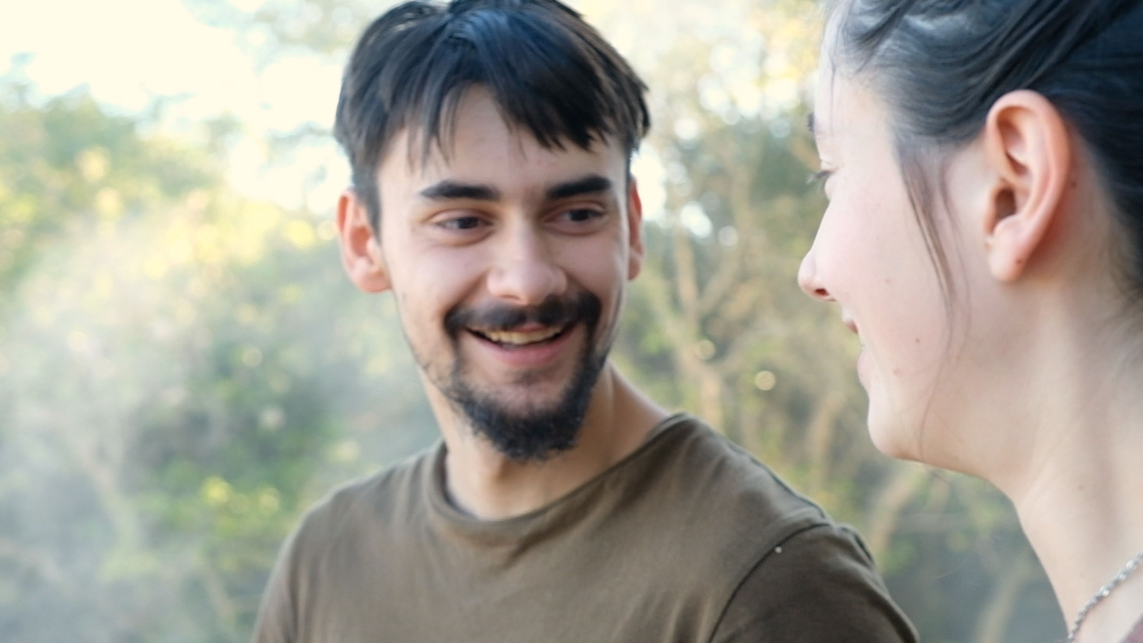 Smiling man and woman chatting outdoors