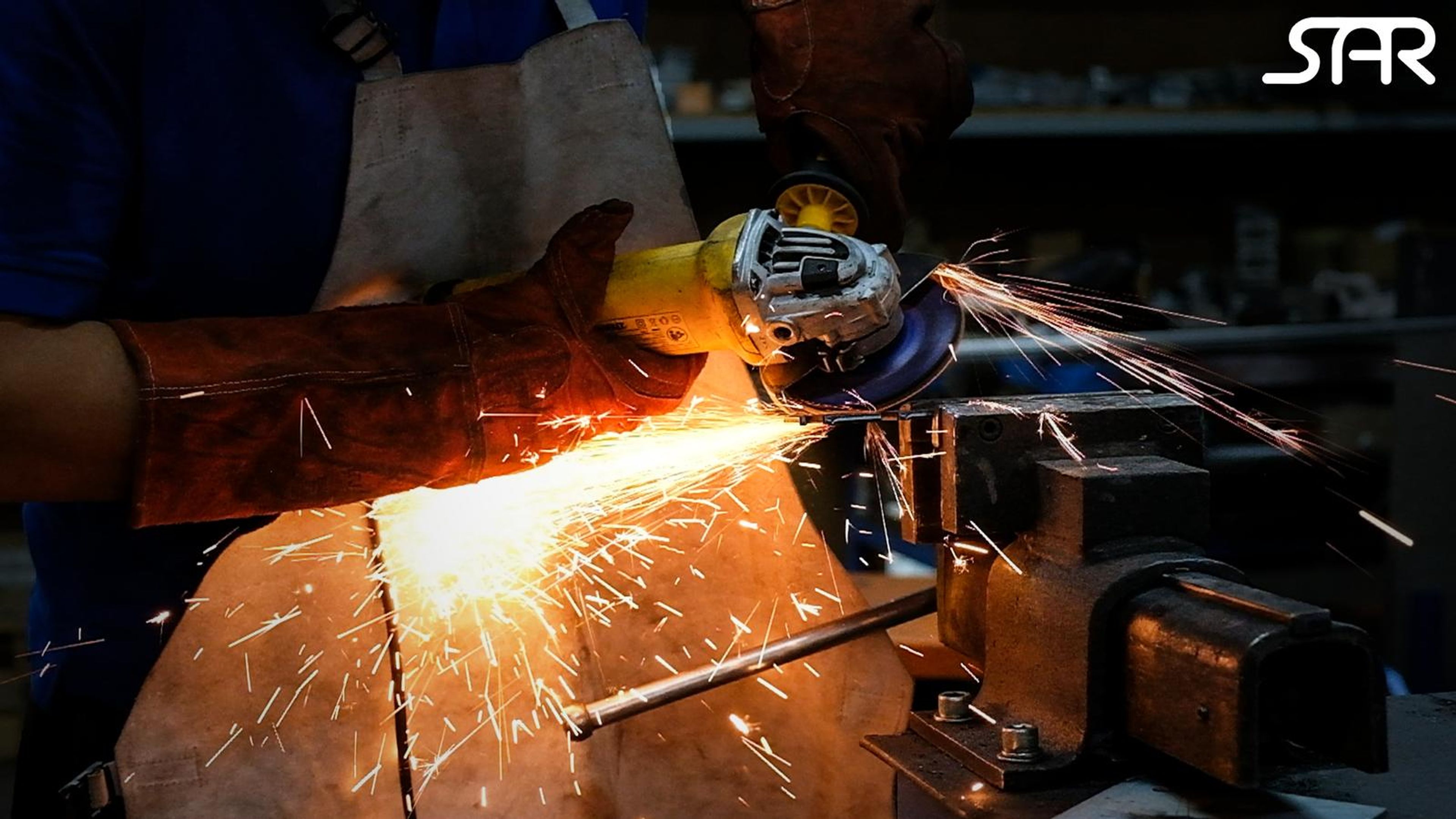 Gloved hands grinding steel with sparks and the SAR logo in white at the top right