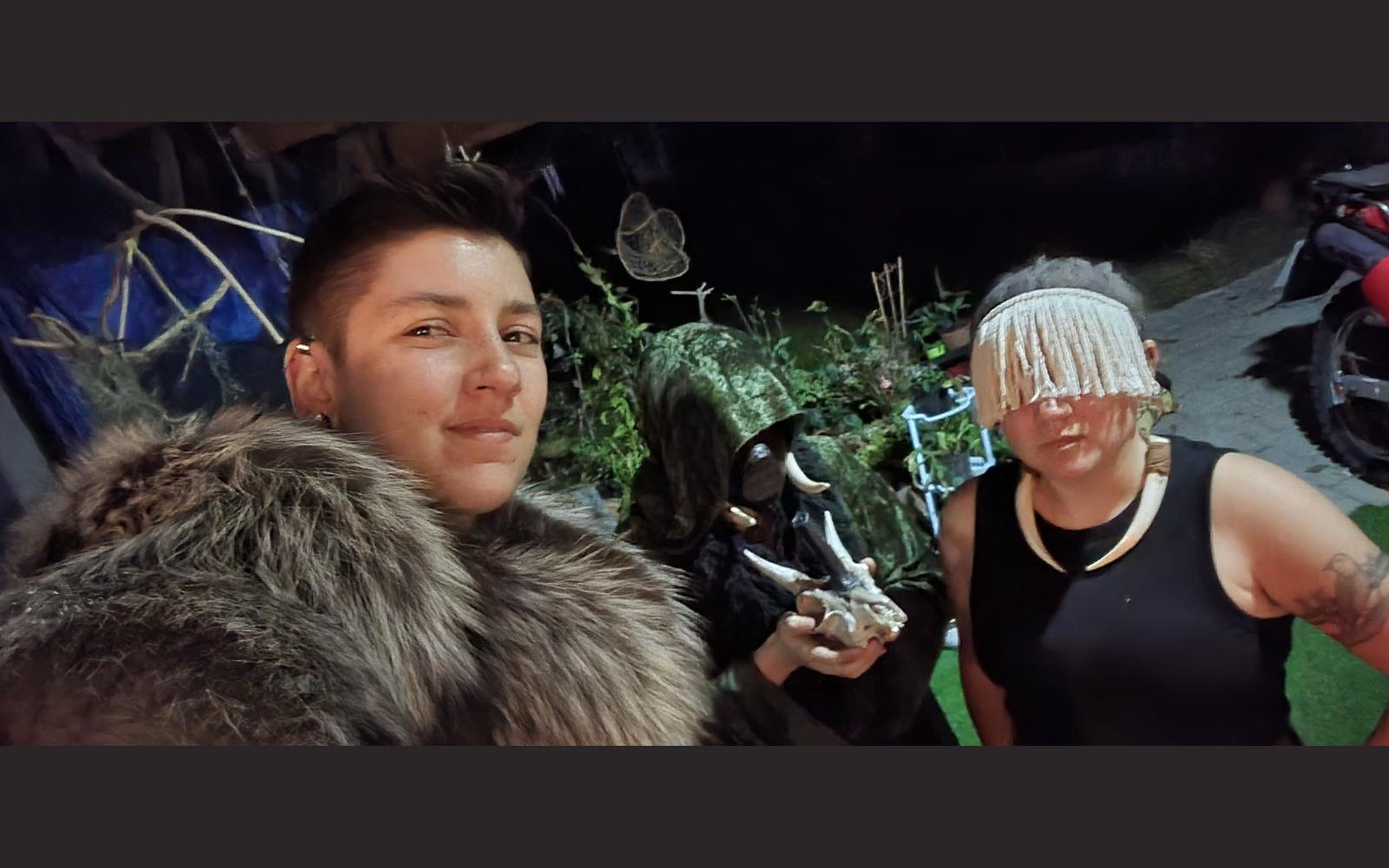 Selfie of a fur-clad barbarian and two costumed performers in a garden before the shoot