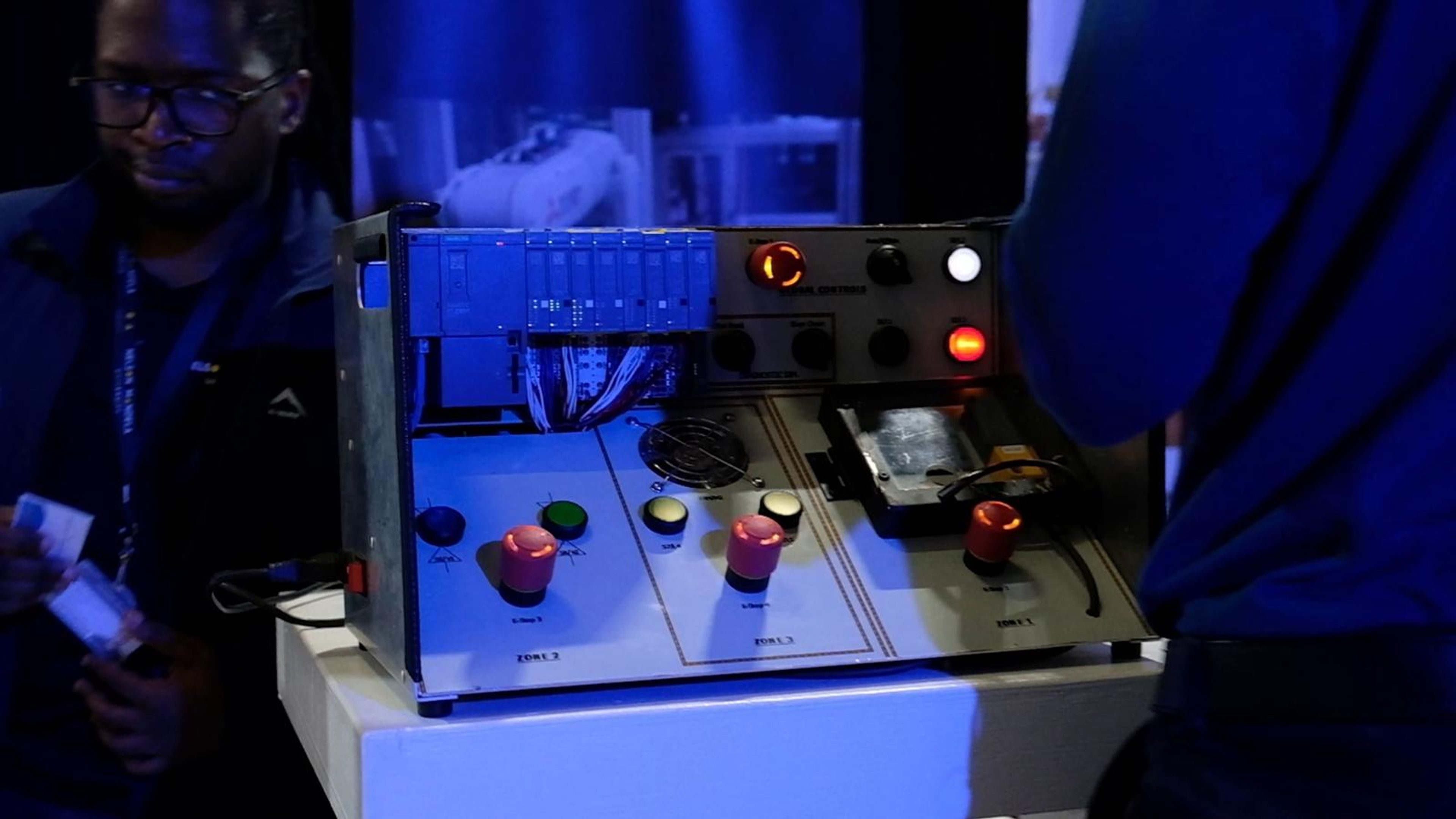 Control panel with illuminated buttons on a demonstration table