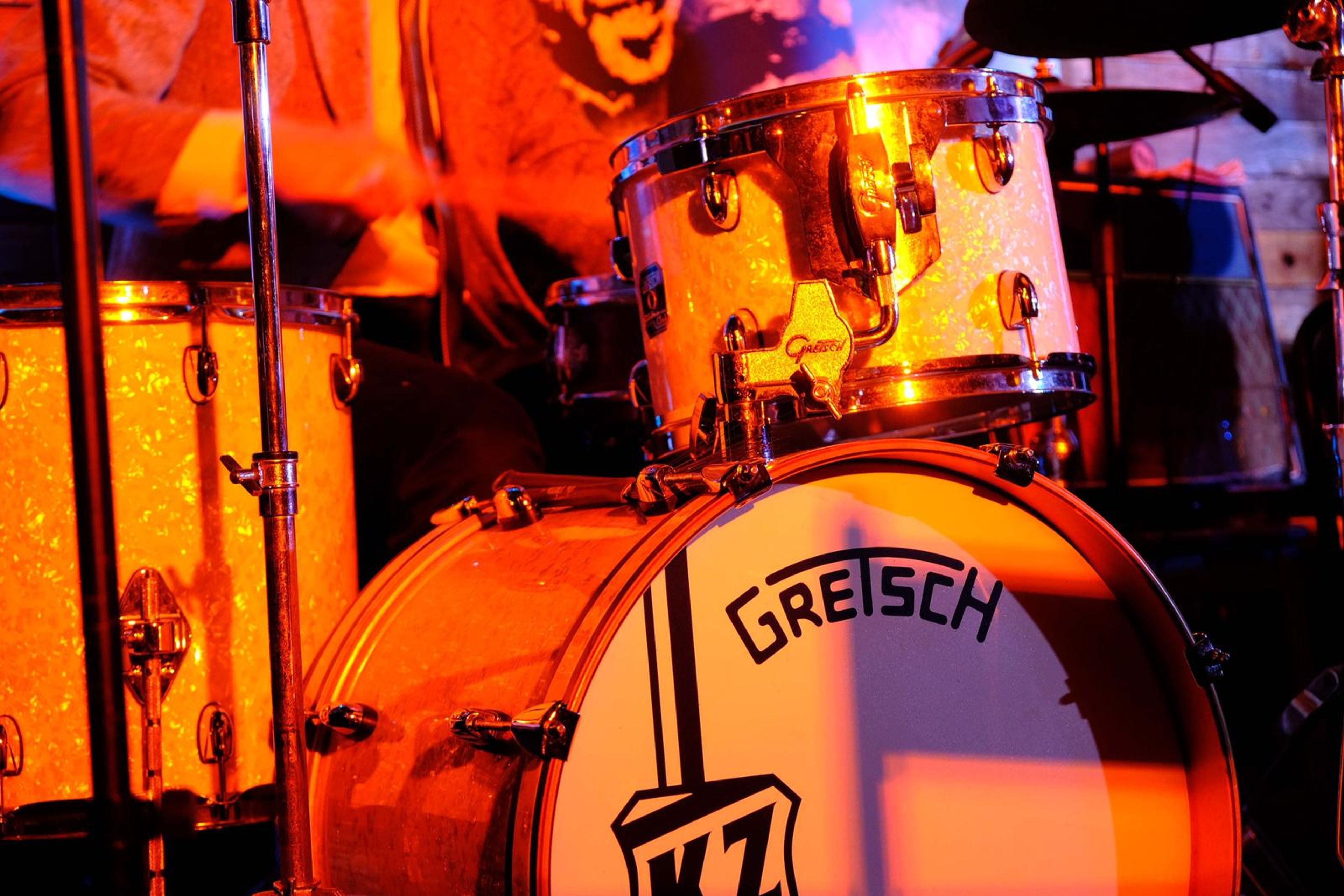 Close-up of the Gretsch bass drum glowing orange