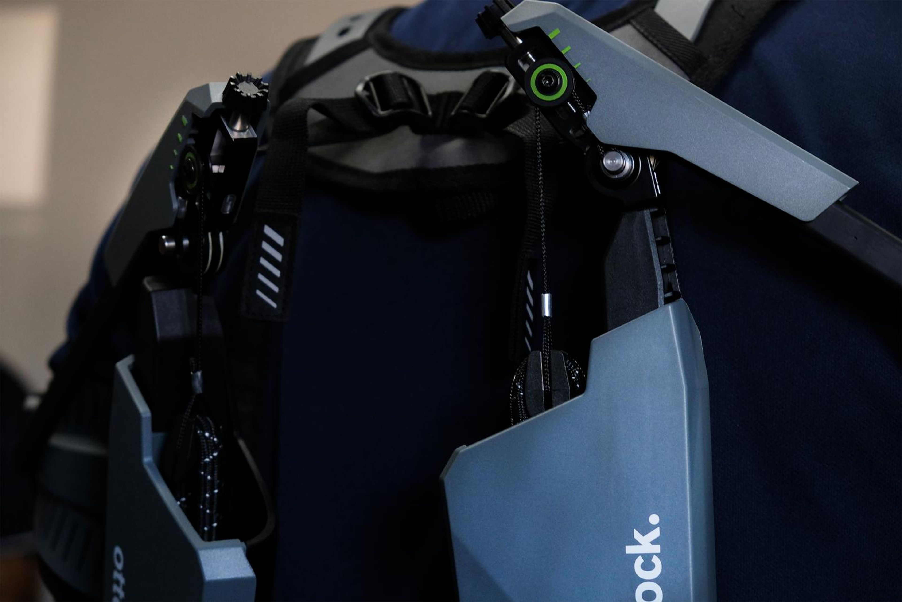 Close view of the exoskeleton's shoulder frame on a visitor's back