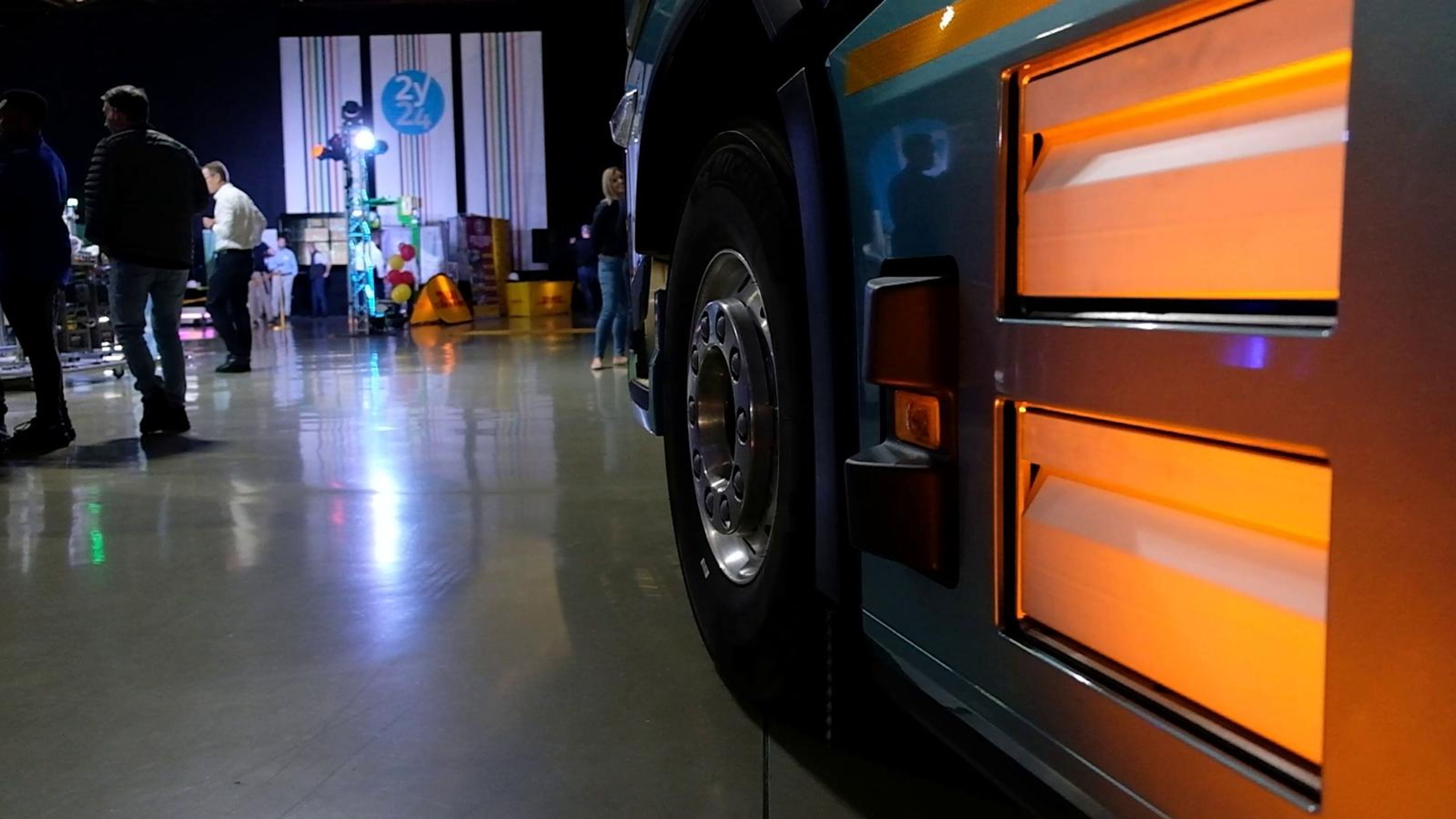 Orange side panel of a truck on the expo floor