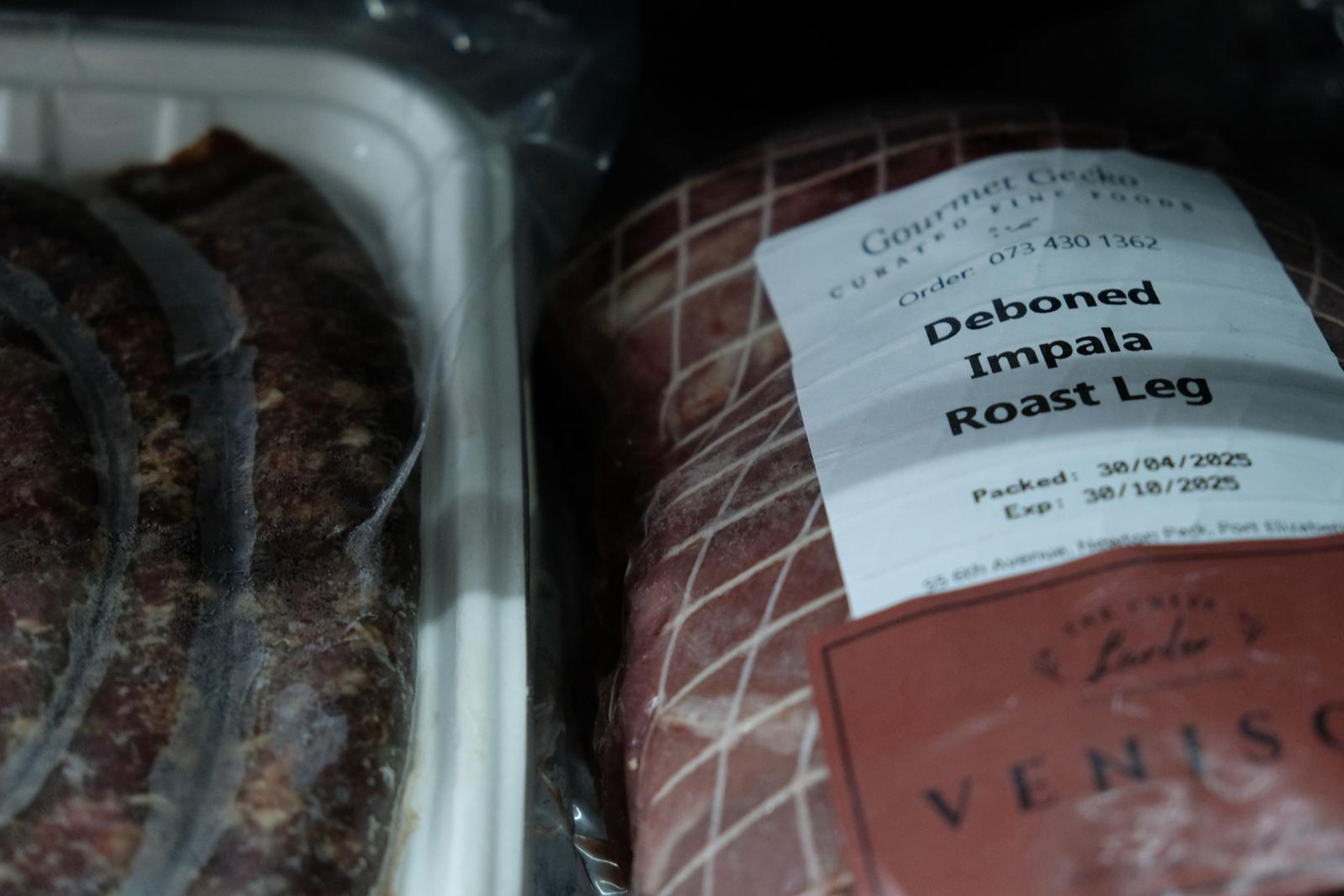 Netted impala roast leg with a Larder label beside a coil of sausage