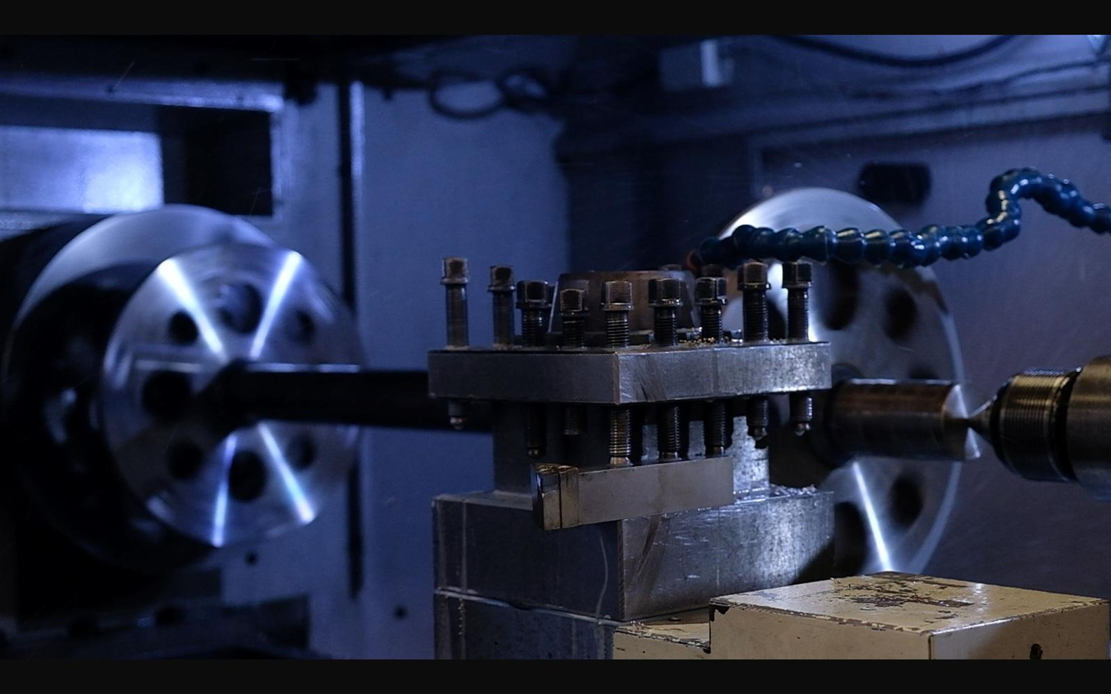 Lathe turning a wheel with coolant