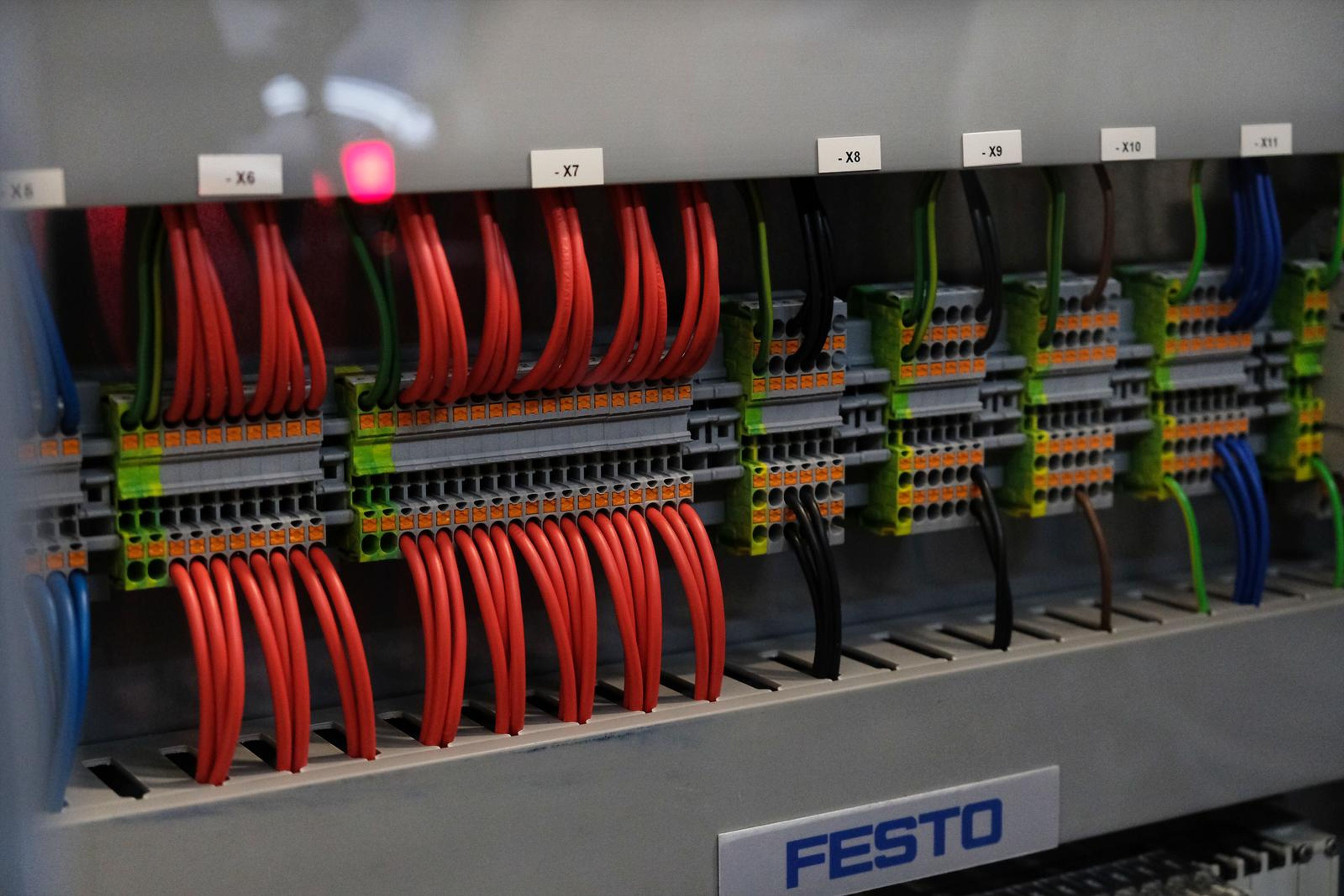 Panel wiring with red jumpers in a demonstration cabinet