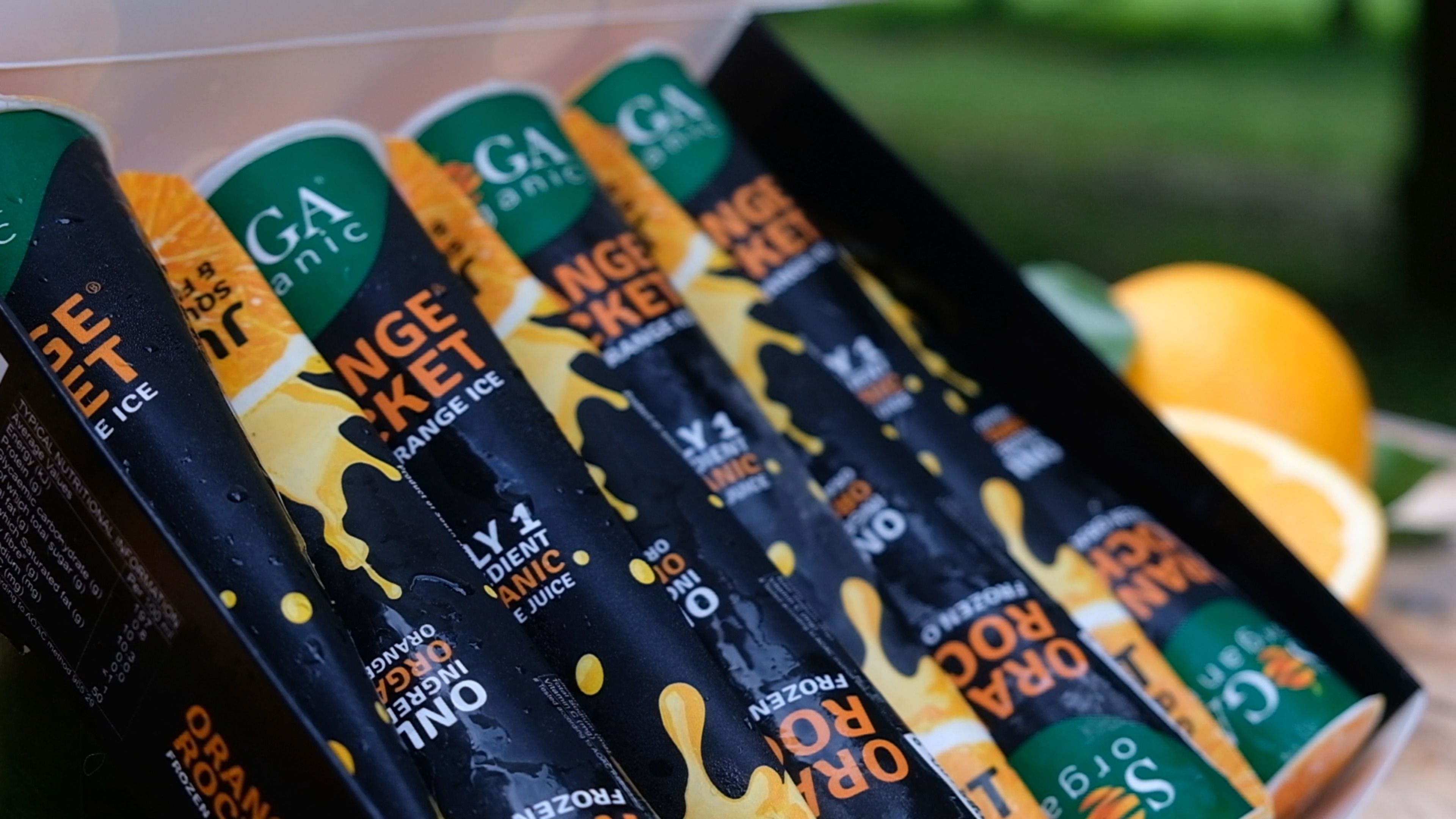 Orange Rocket frozen orange ice sticks in an open box with an orange
