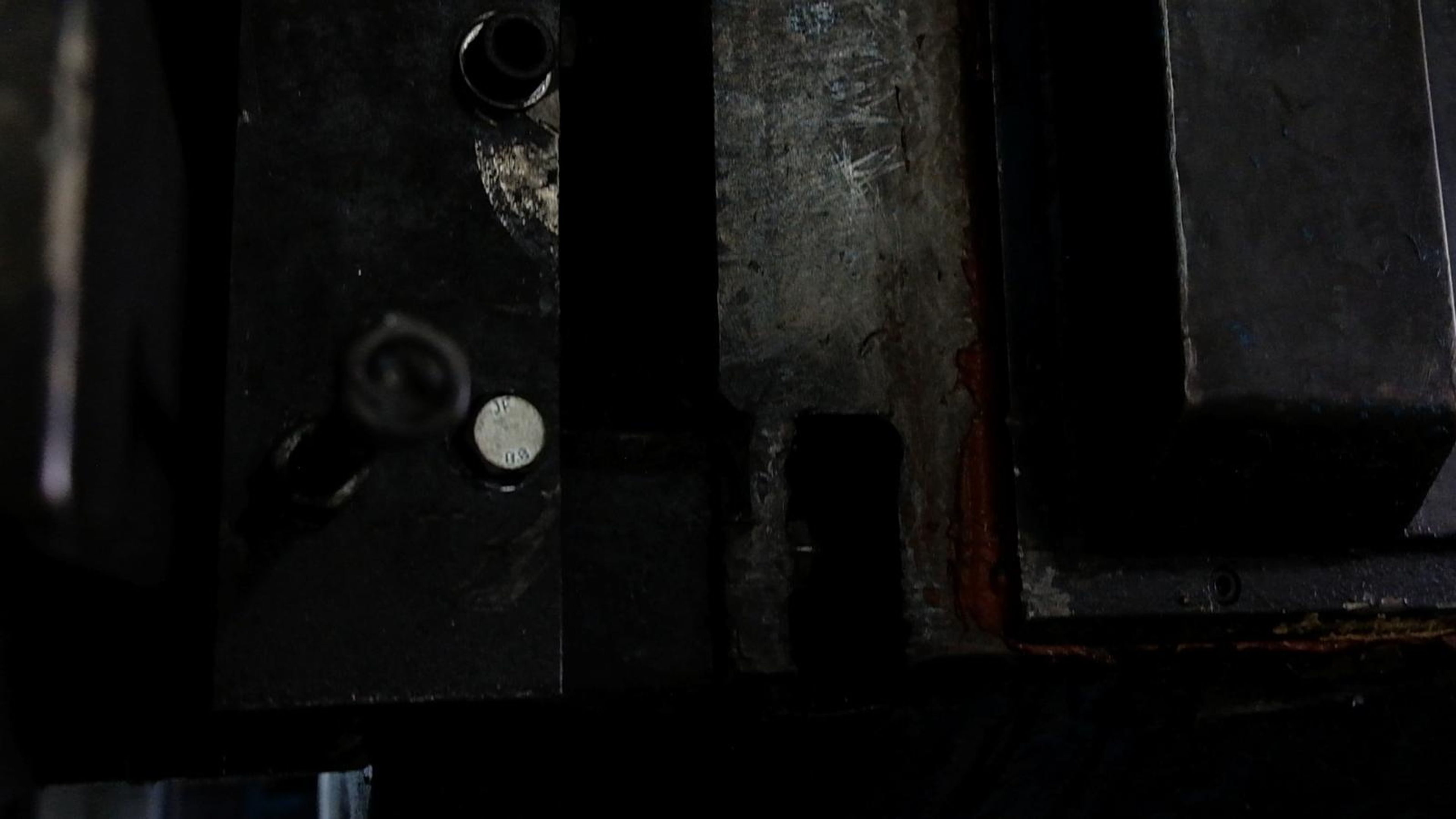 Dark machine fixture with a steel clamp block
