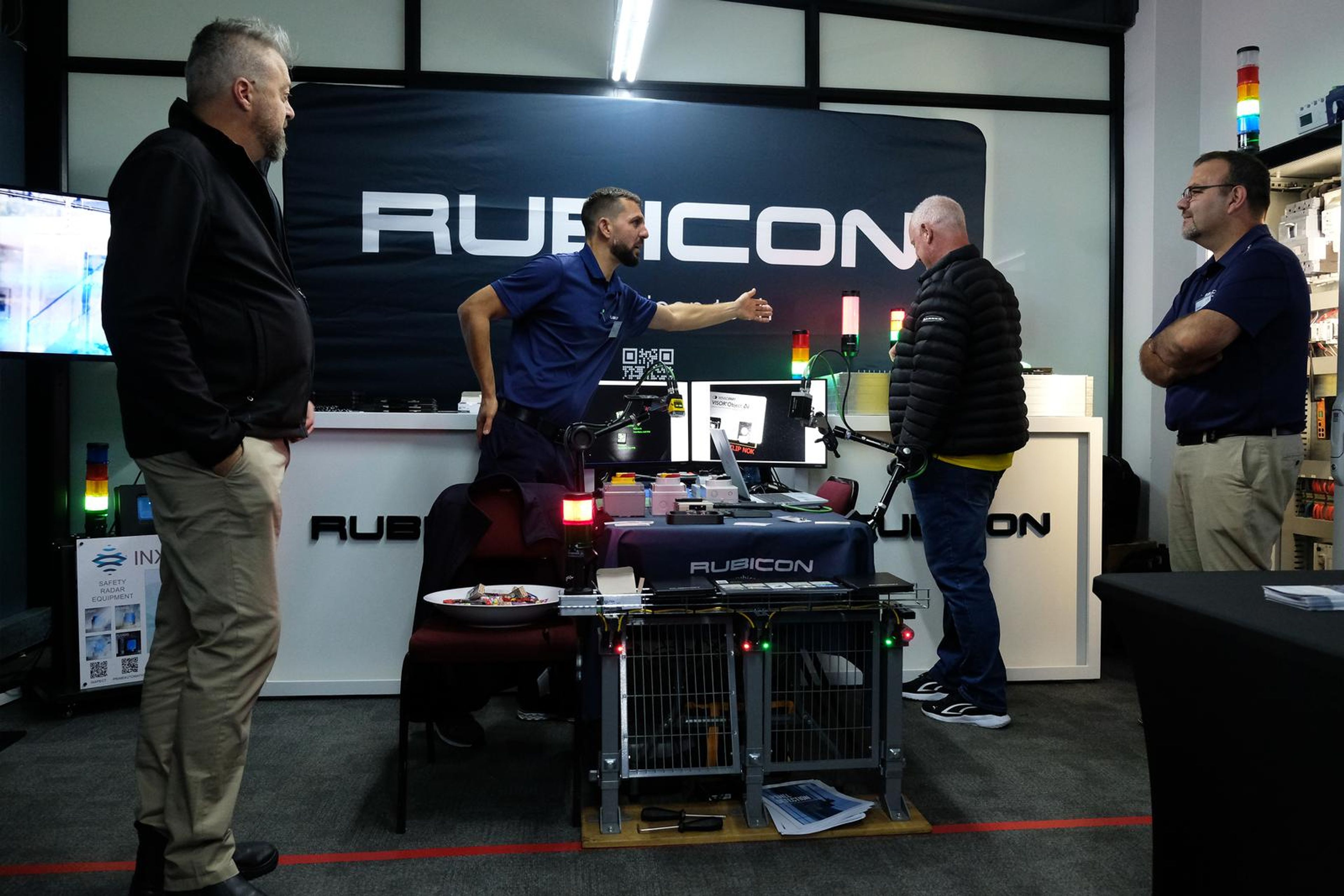 Rubicon staff talking with a visitor at the stand