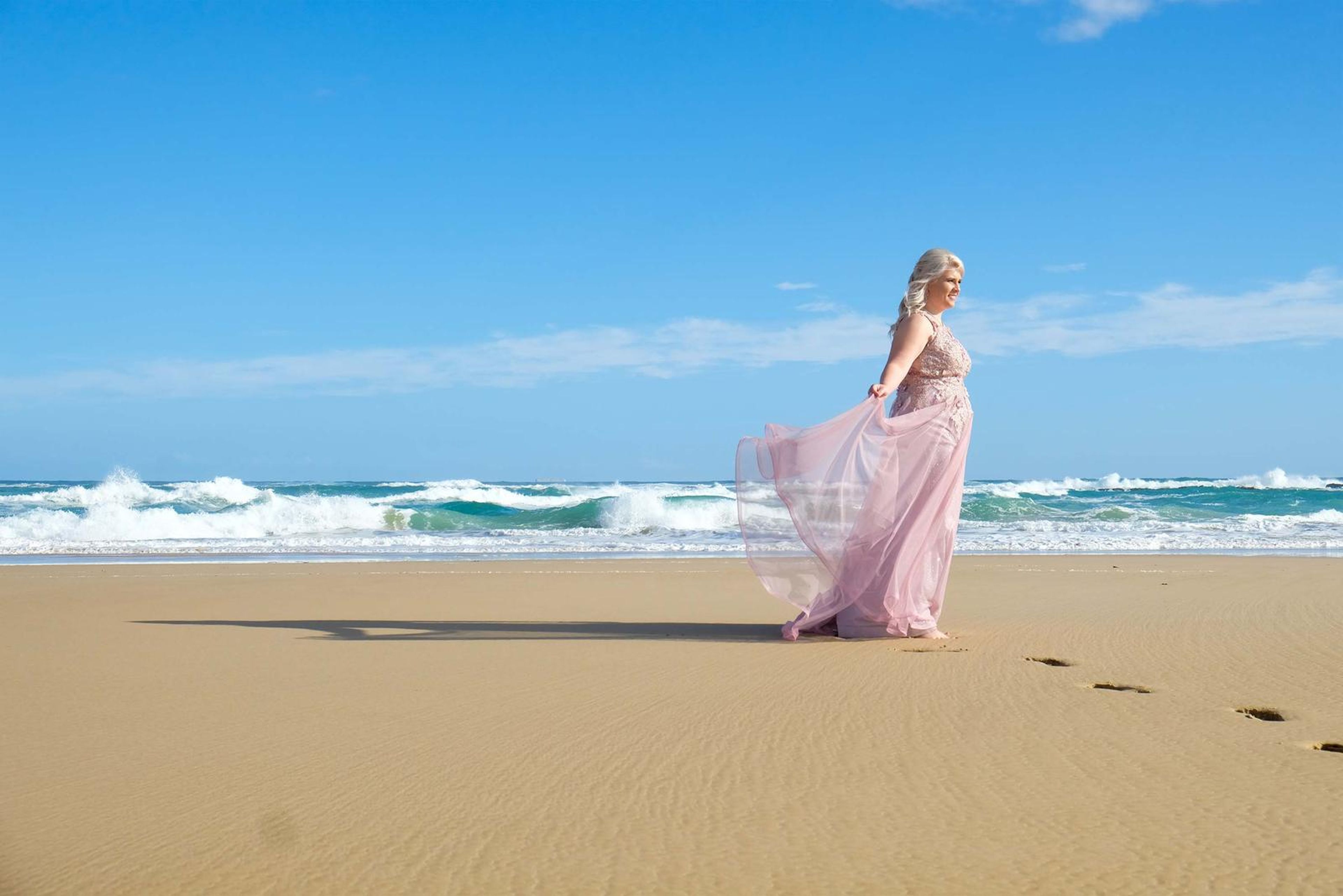 Gown twirling beside the waves