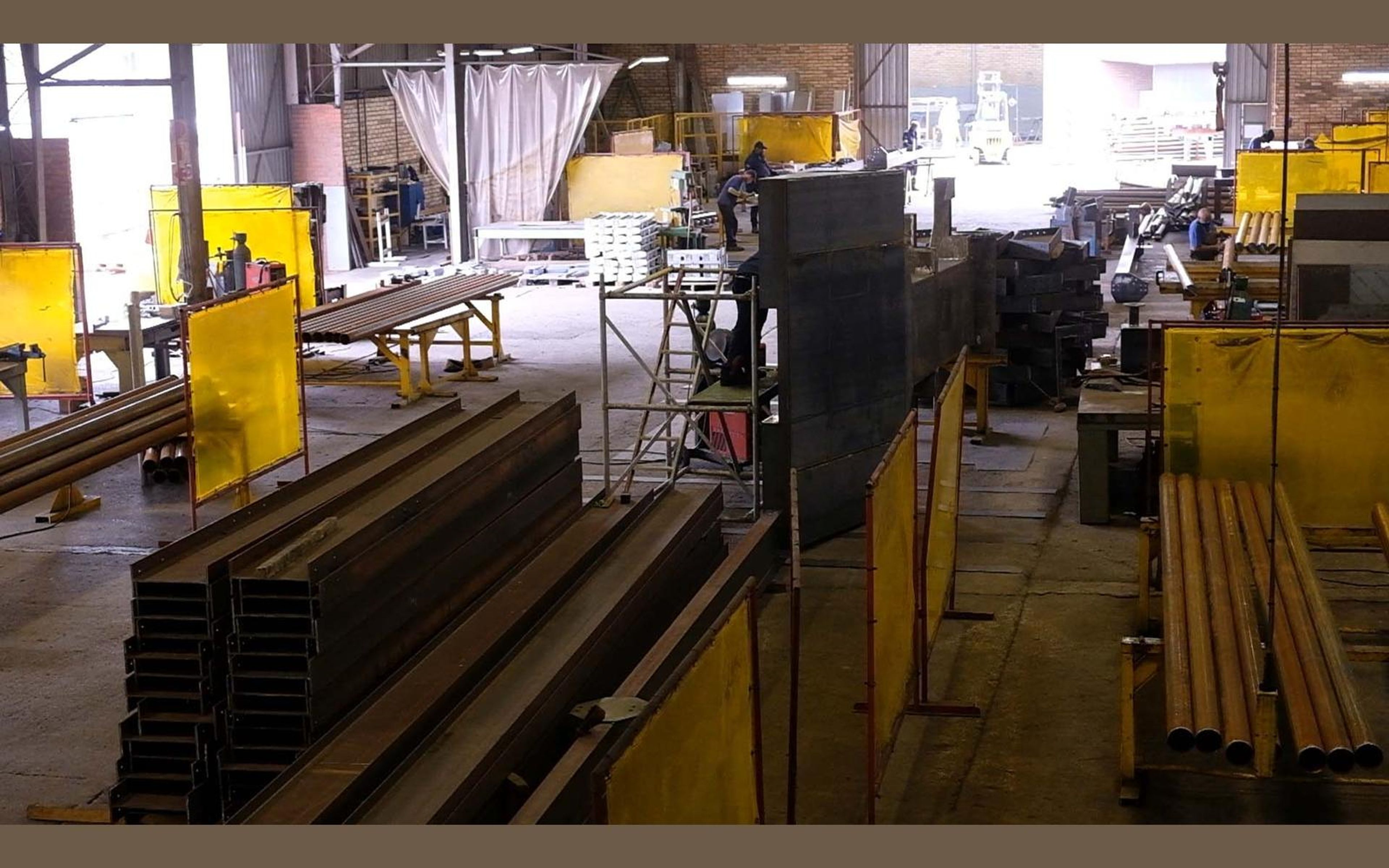 Steel frames laid out across the fabrication sector floor