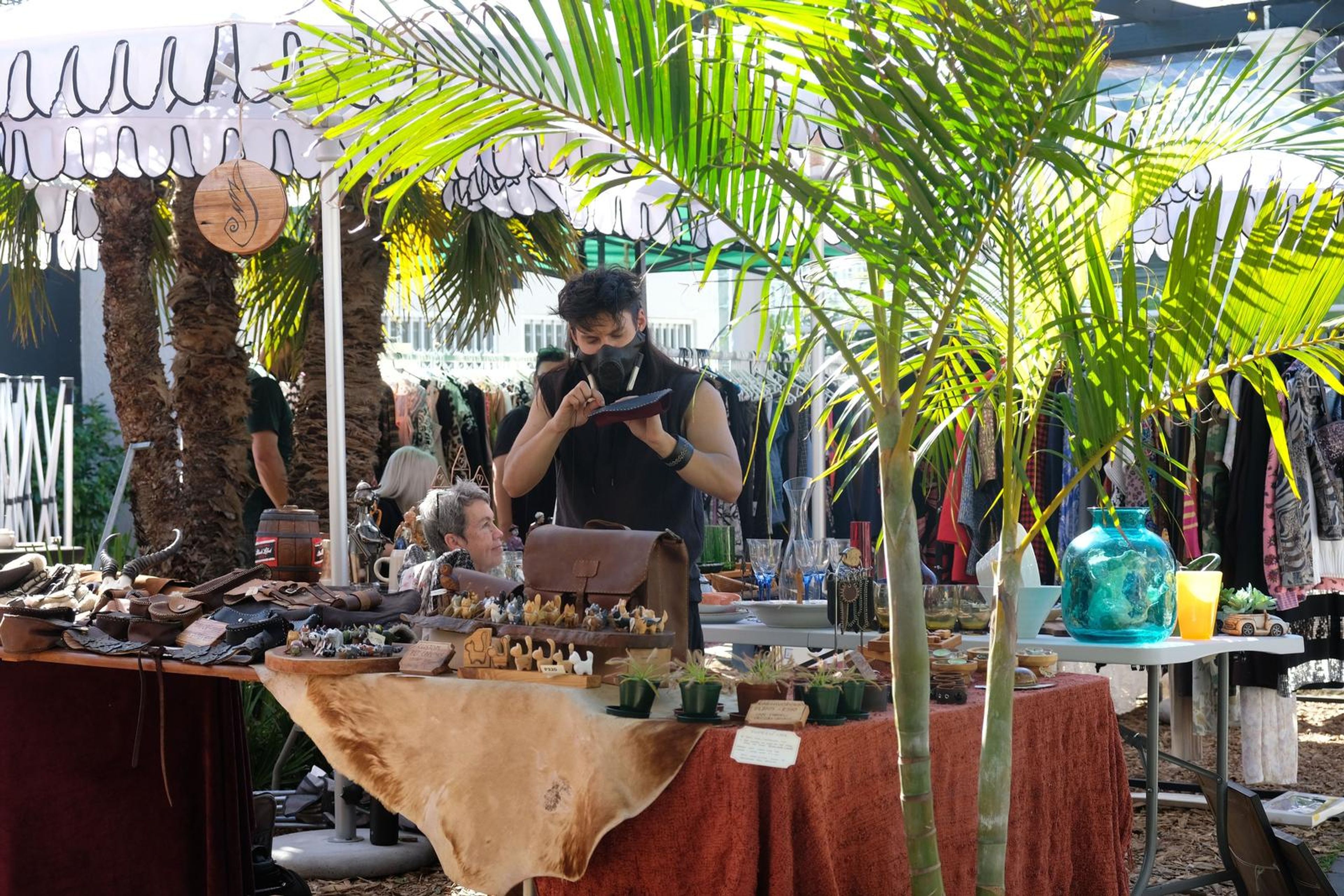 Juuks maker at the stall under the palm trees at Filthy McNasty's market