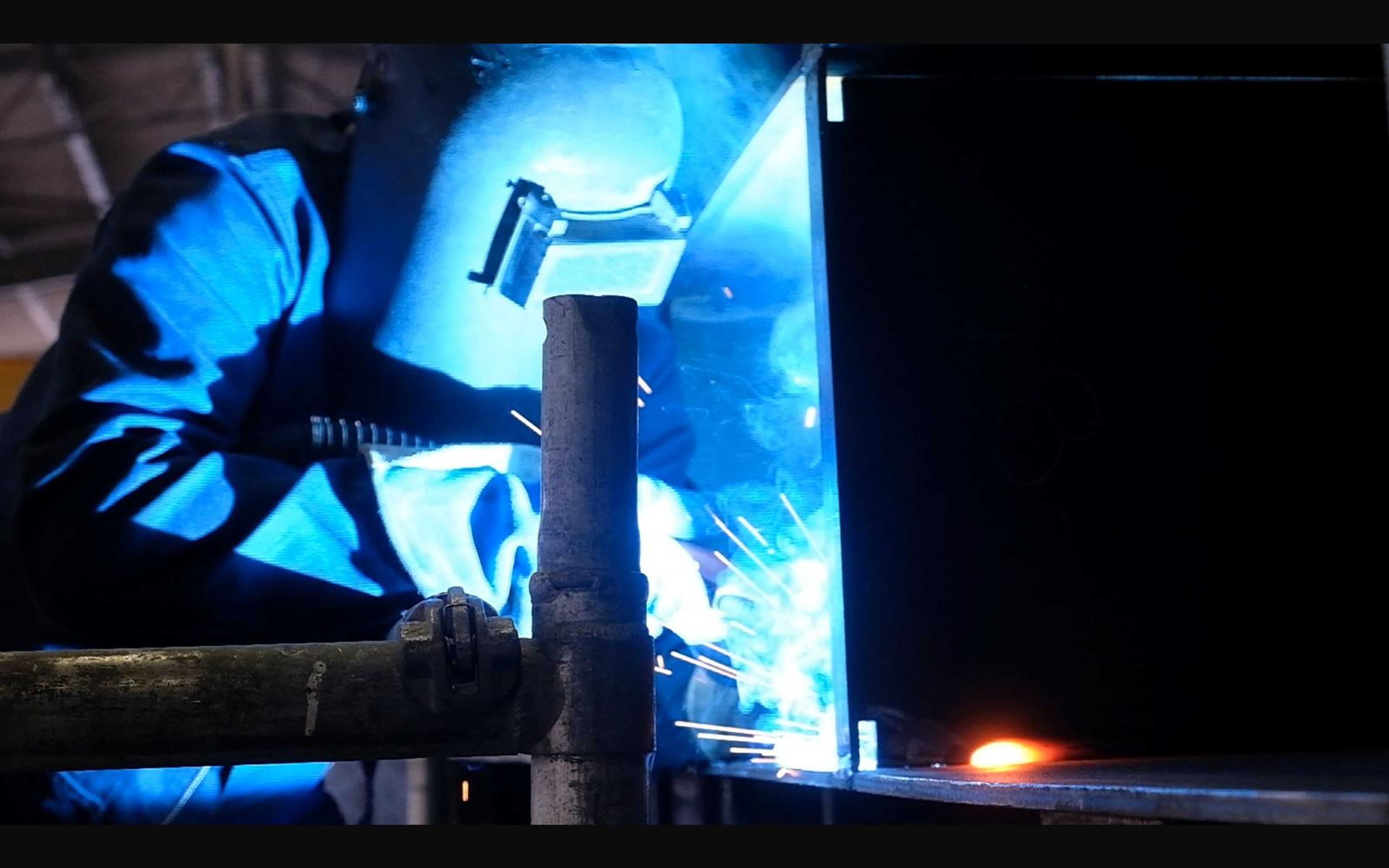 Welder working inside a steel structure