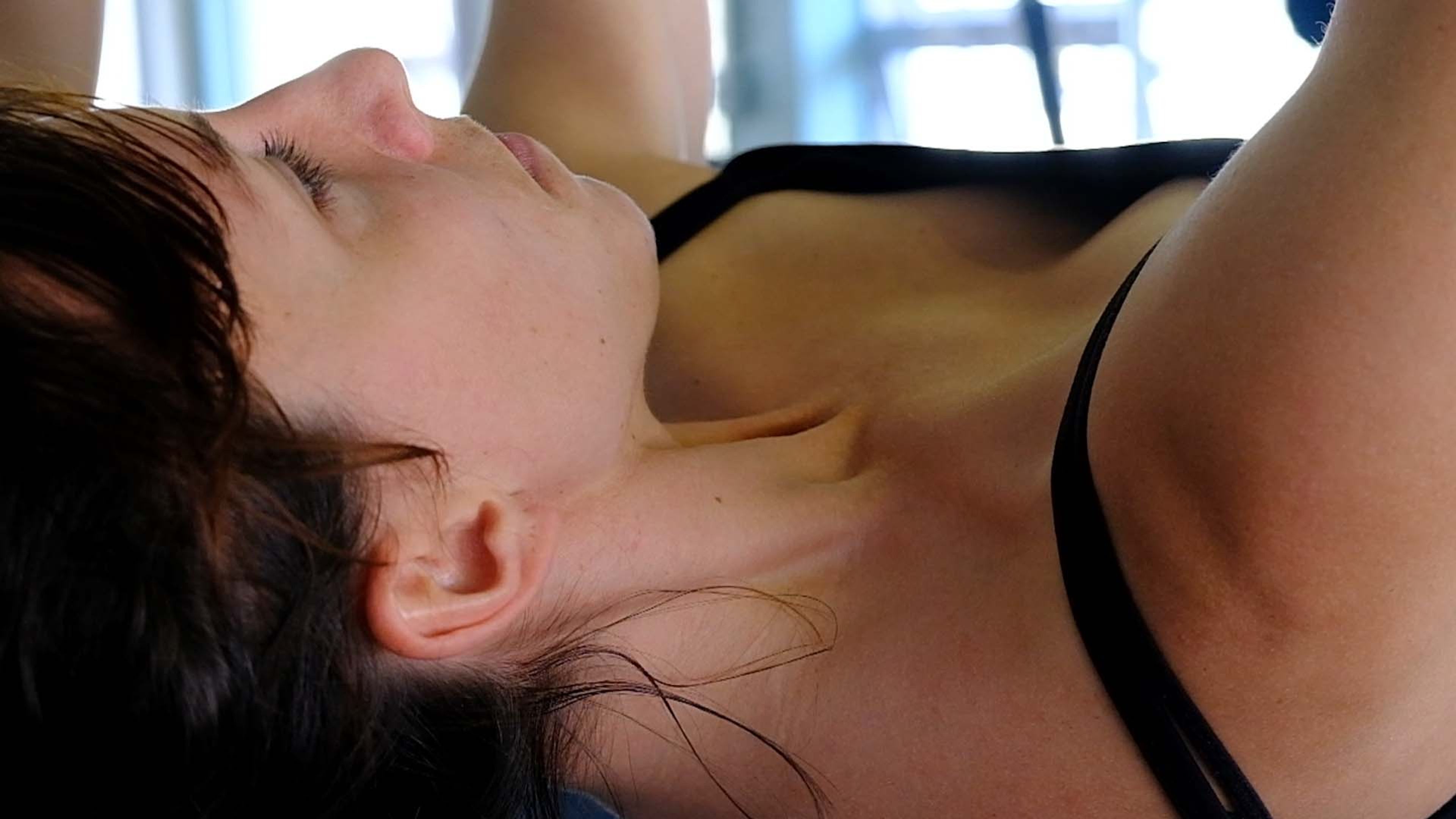 Woman lying back with her eyes closed during a treatment
