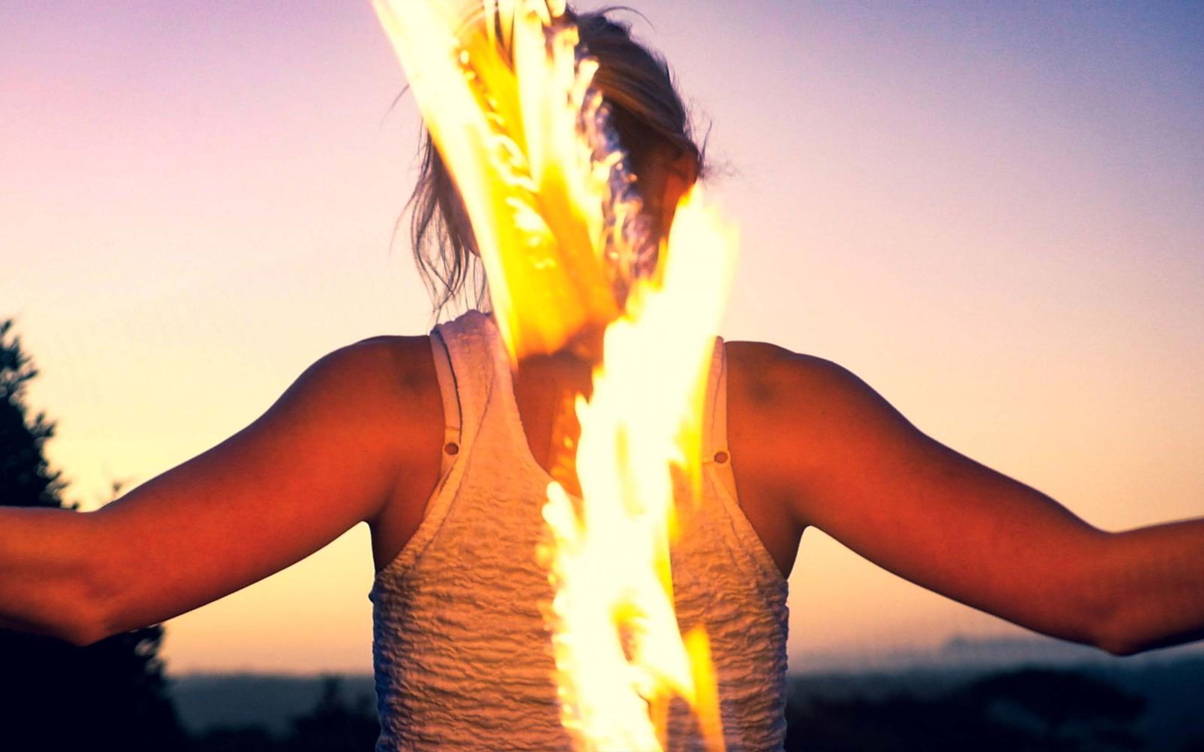 Darker, warmer version of the woman from behind with flames on both sides of her head