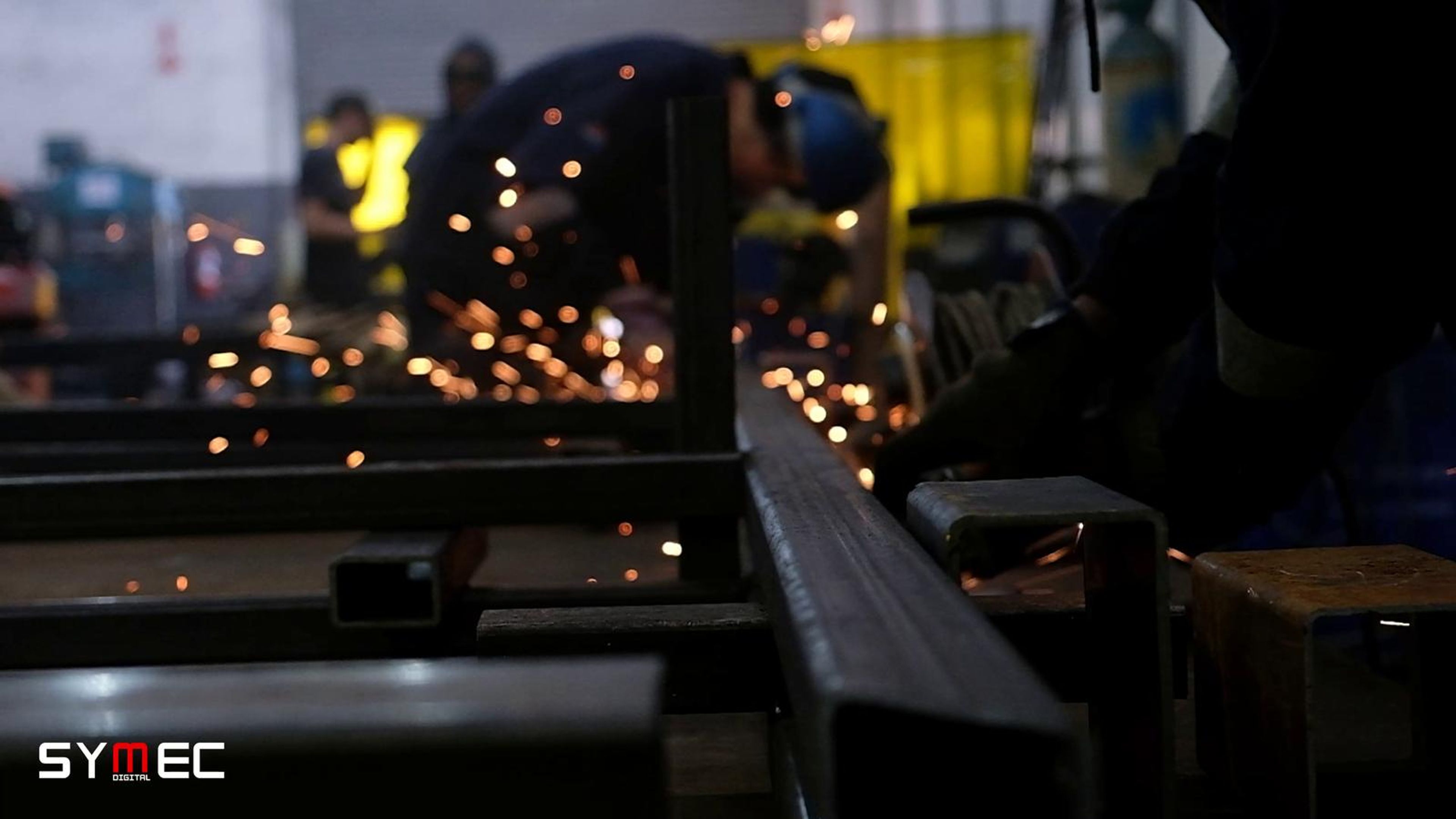 Orange sparks streaming past steel columns