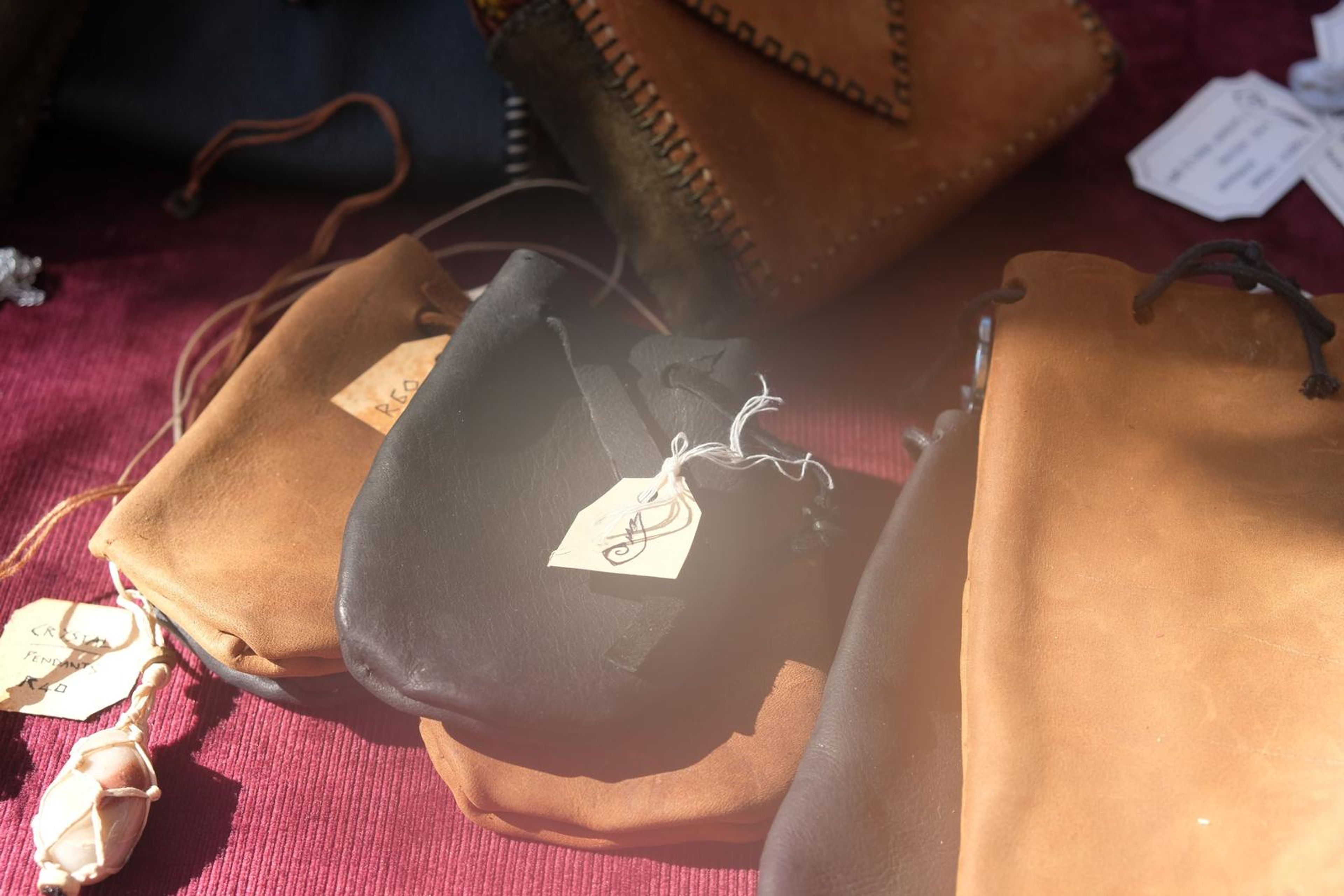 Leather drawstring pouches with handwritten tags