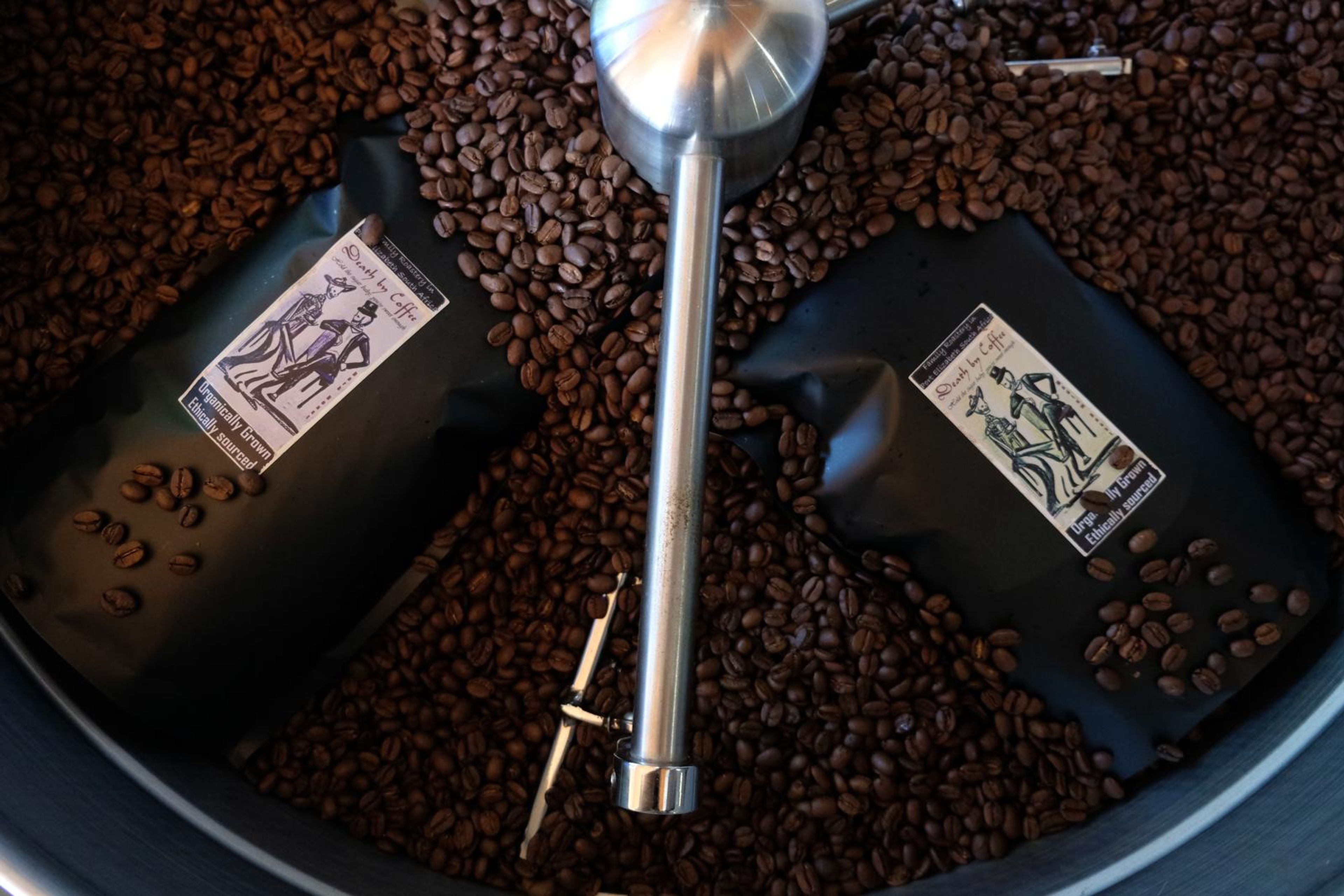 Death By Coffee creative product photography of coffee, beans and branded bags