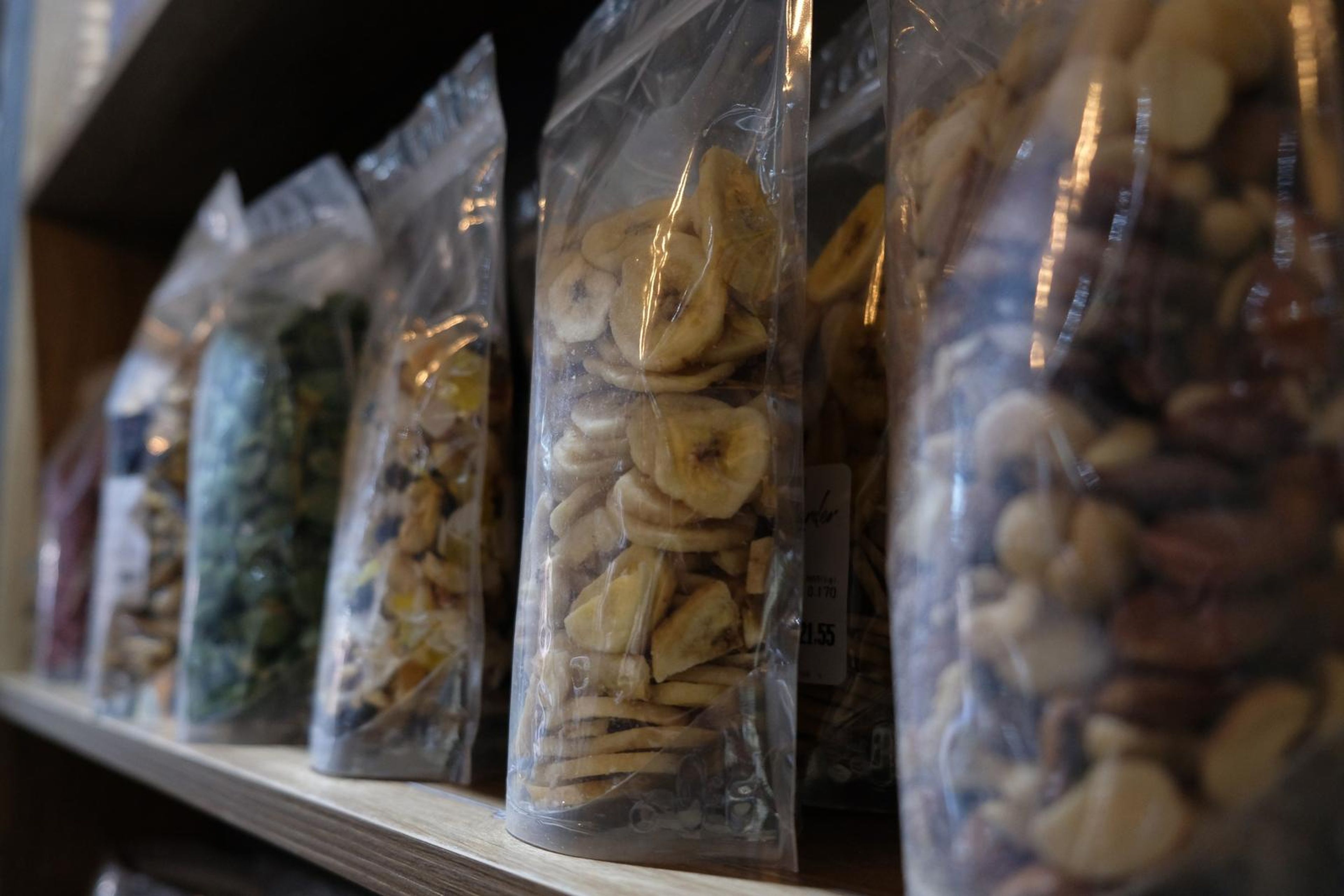 Bags of dried fruit, nuts and seeds on a shelf