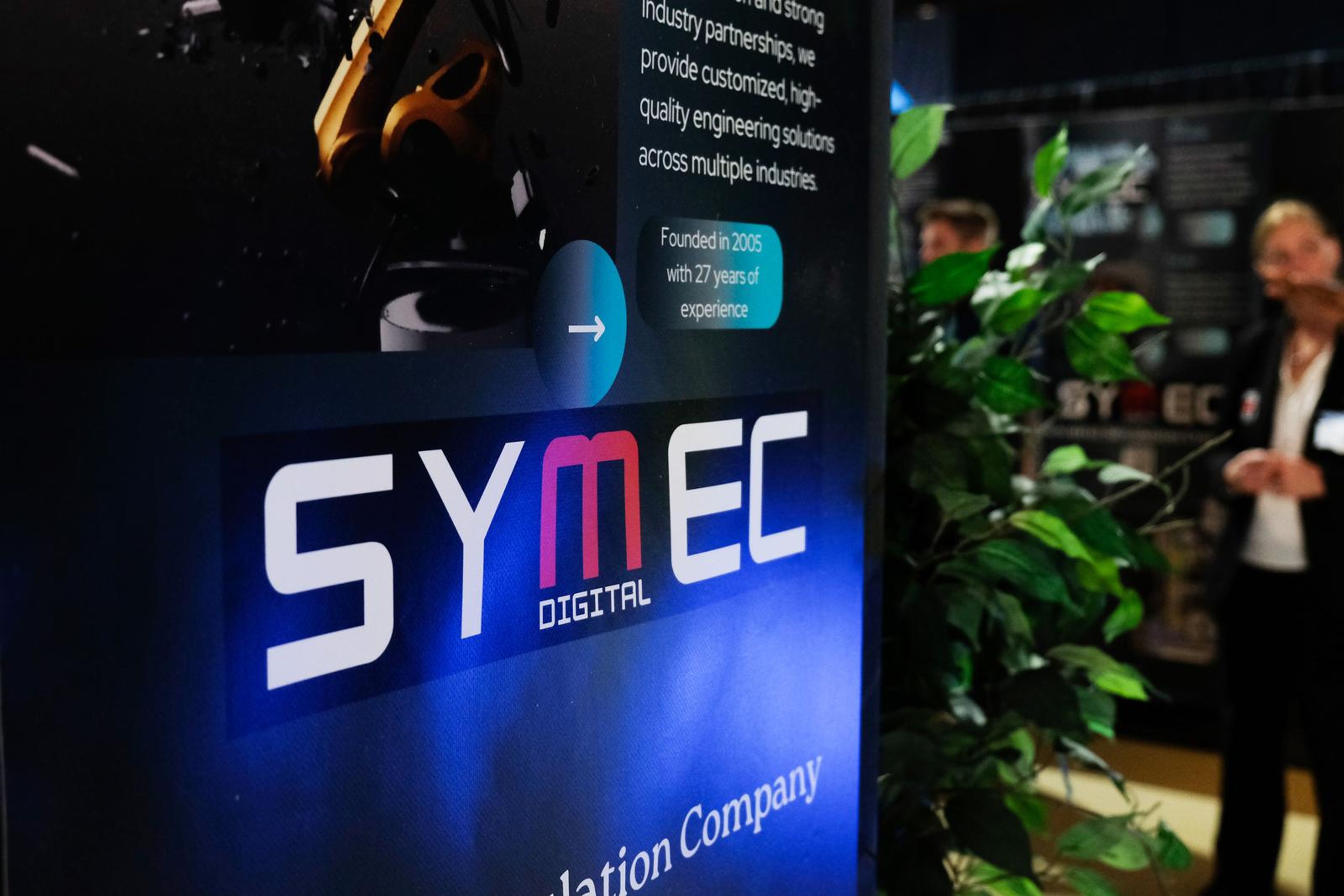 Symec Digital stall sign with a robot arm above