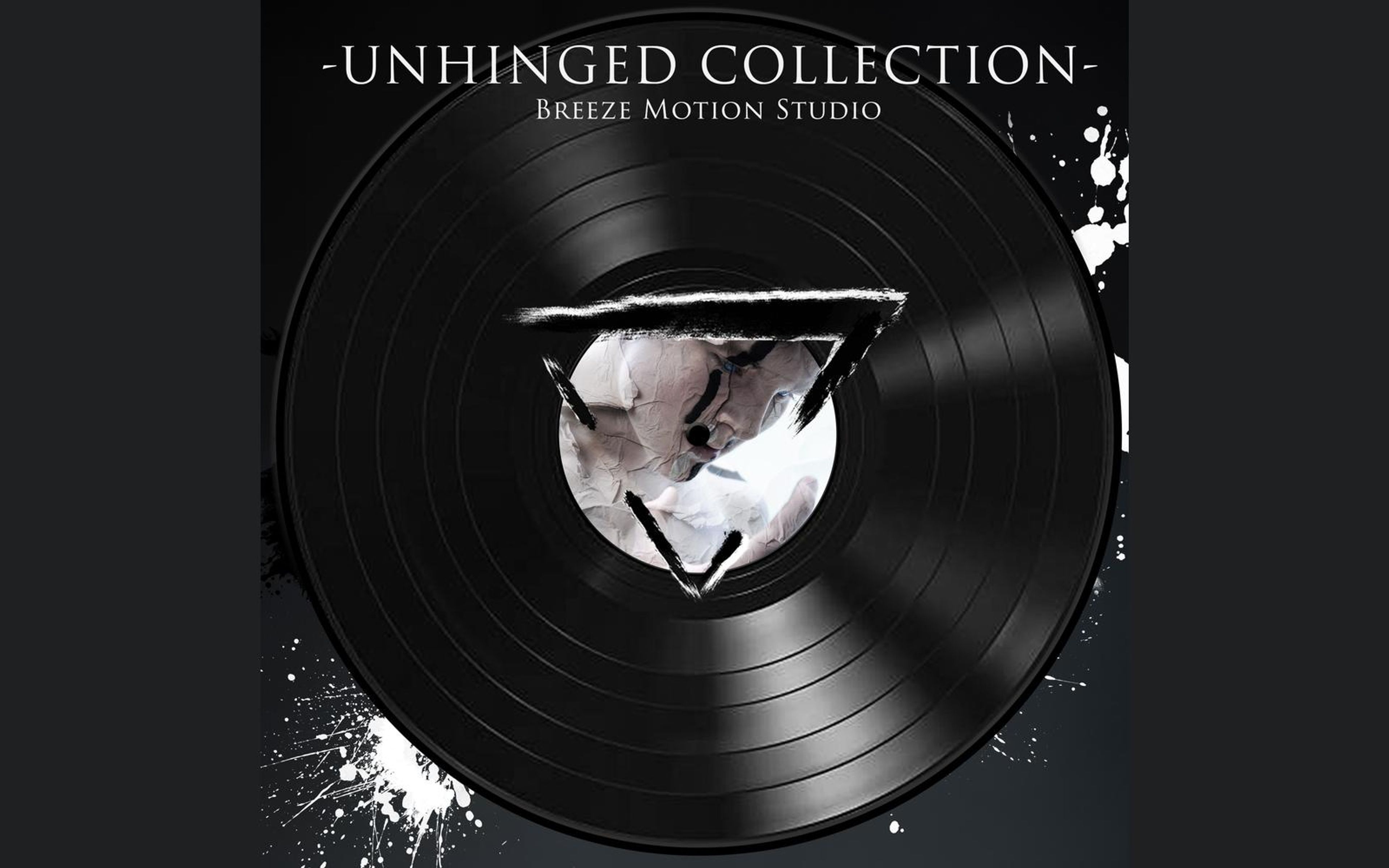 Black vinyl record on a dark splattered background with a studio triangle logo on its centre label and the collection title above