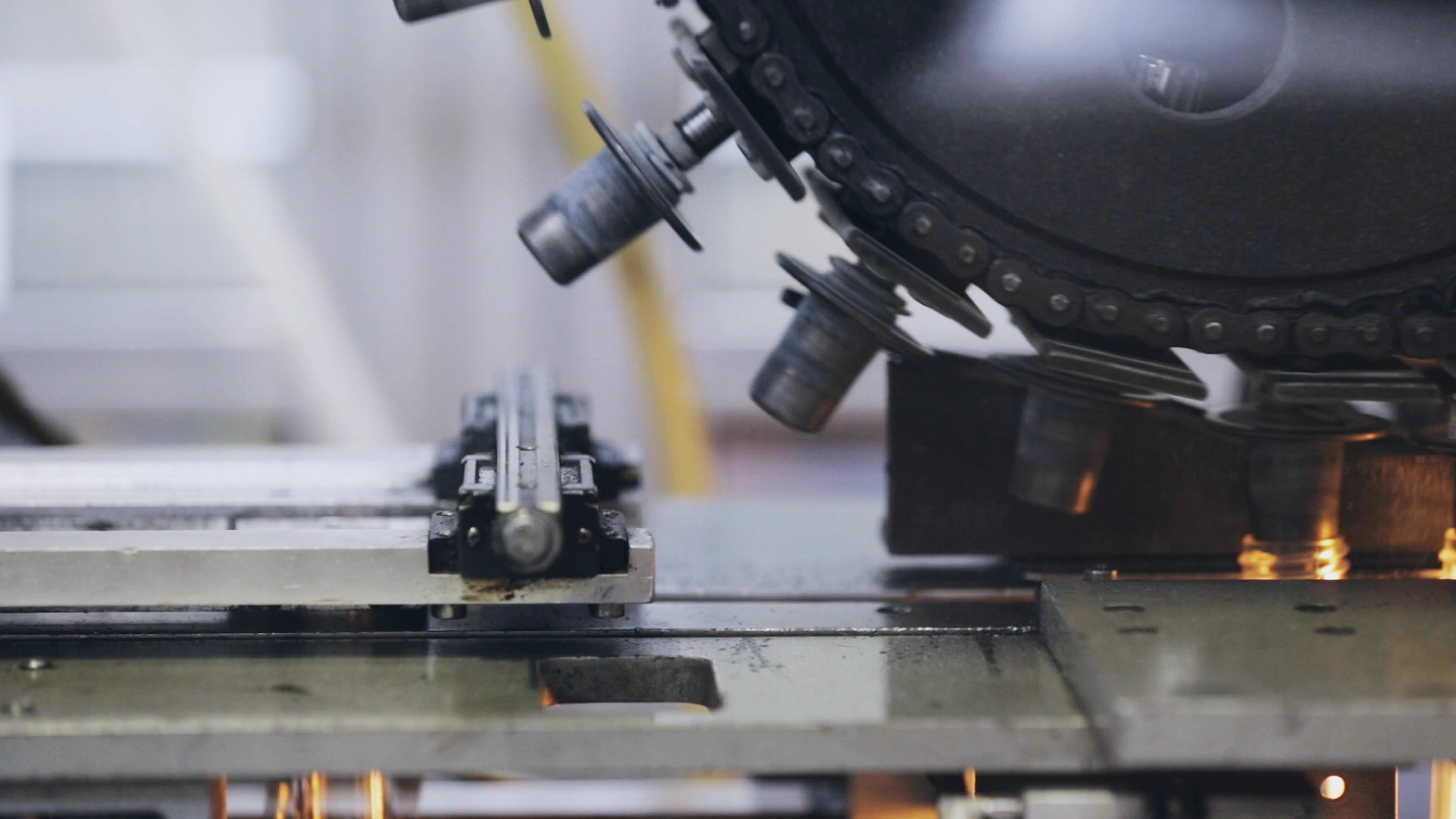 Close view of a large machine with lenses and a metal sheet