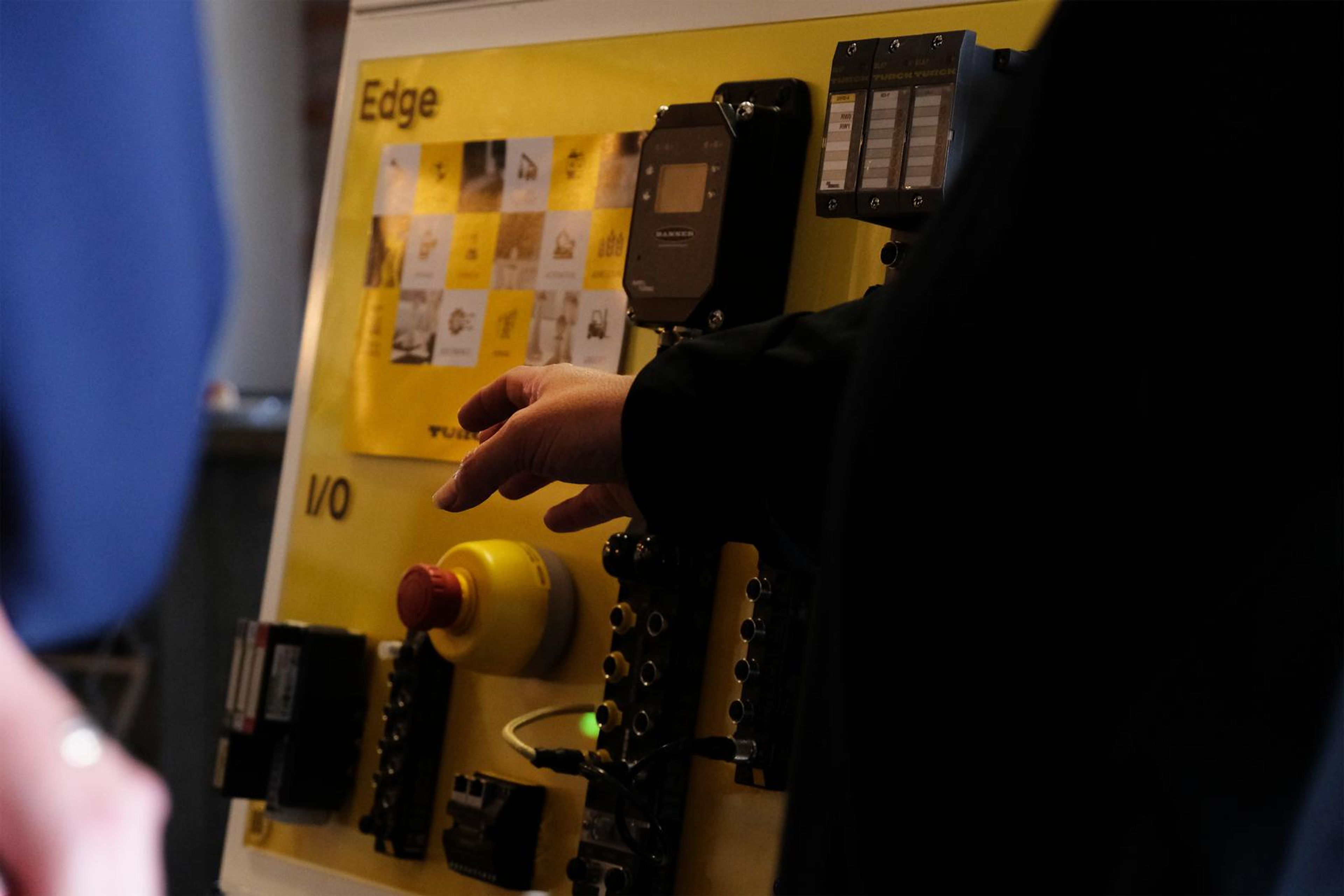 Visitor pressing a button on a Turck I/O demonstration panel