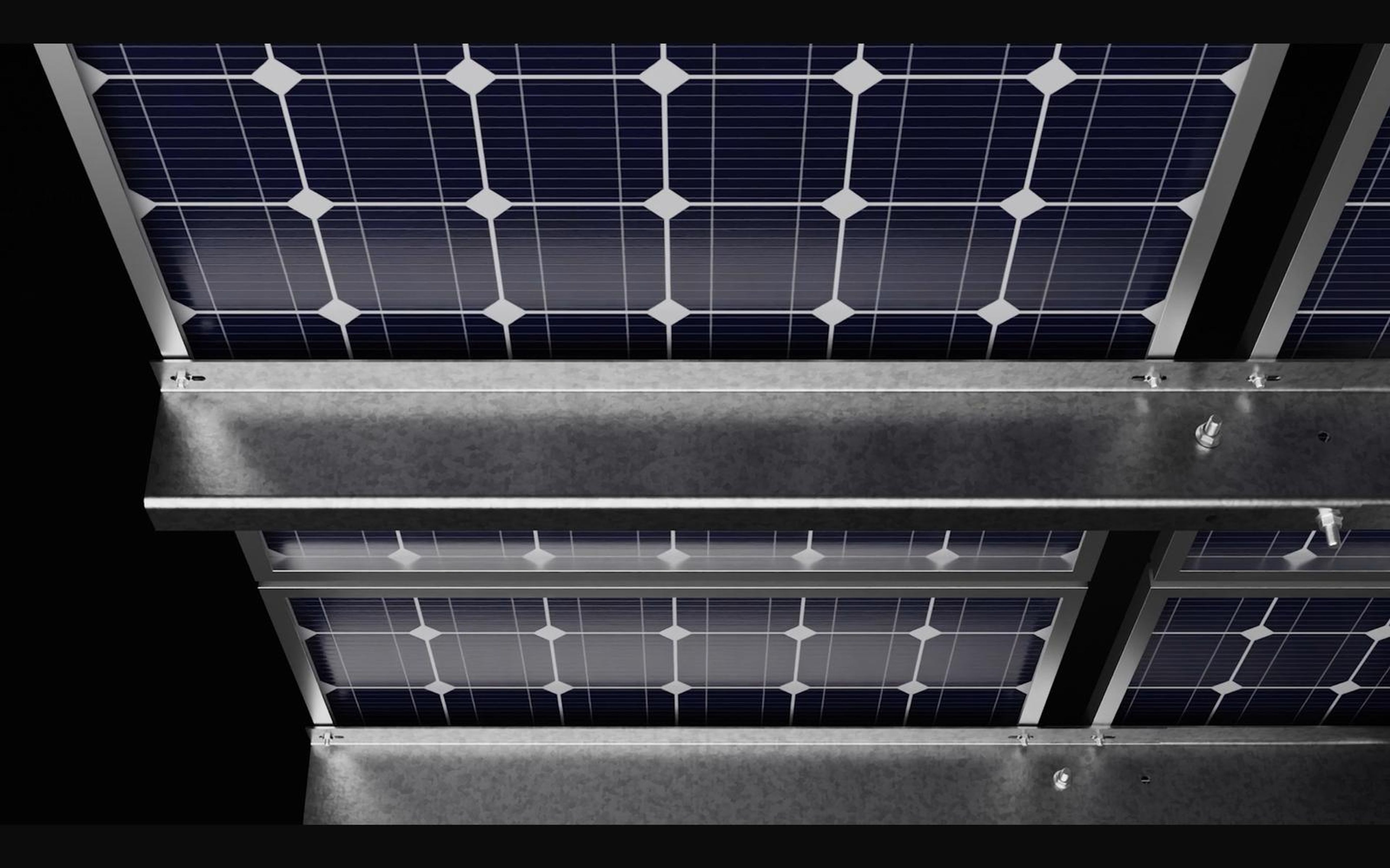 Close view of solar panels clamped to galvanised rails