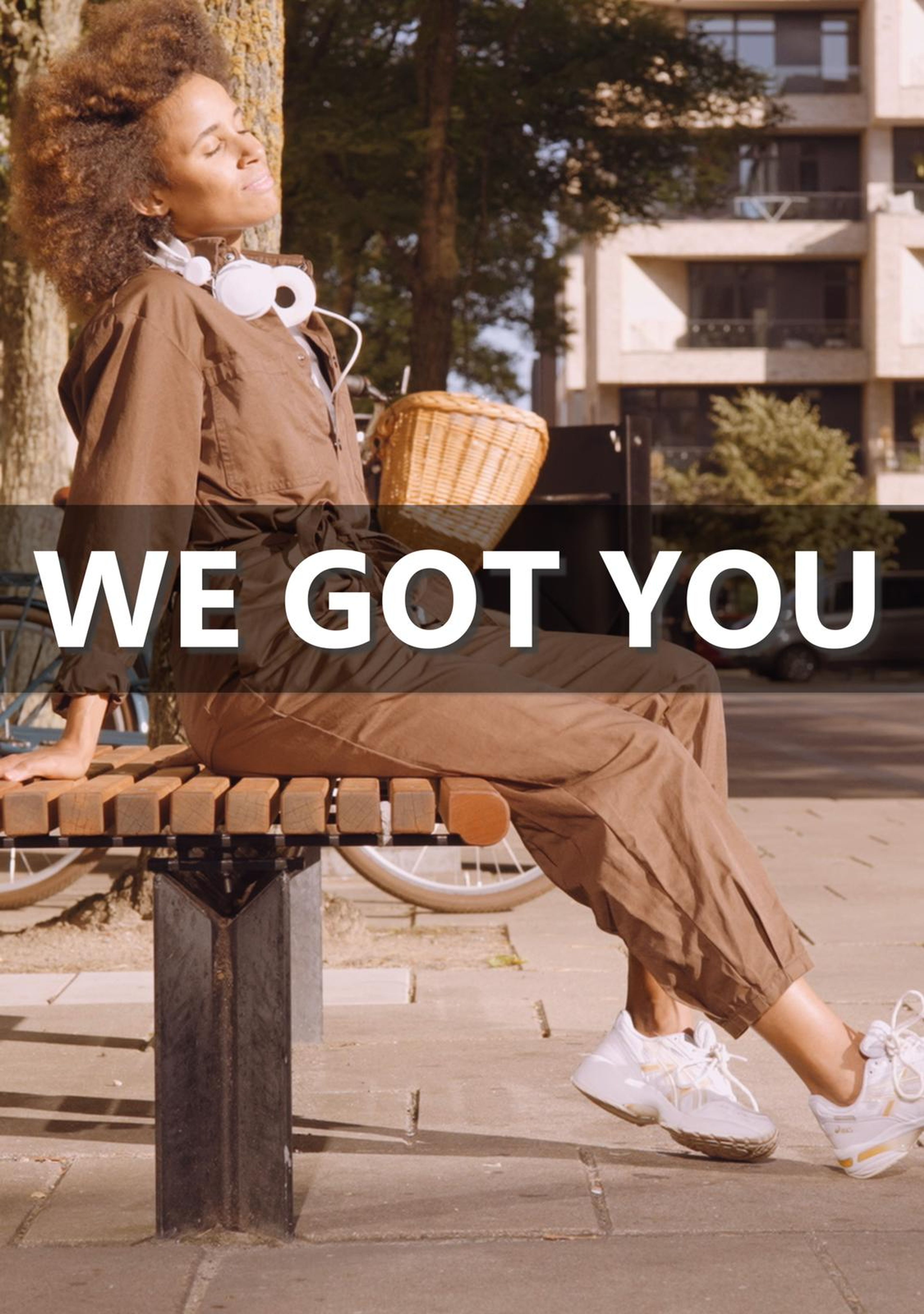 Vertical frame with the text We Got You over a woman sitting on a bench