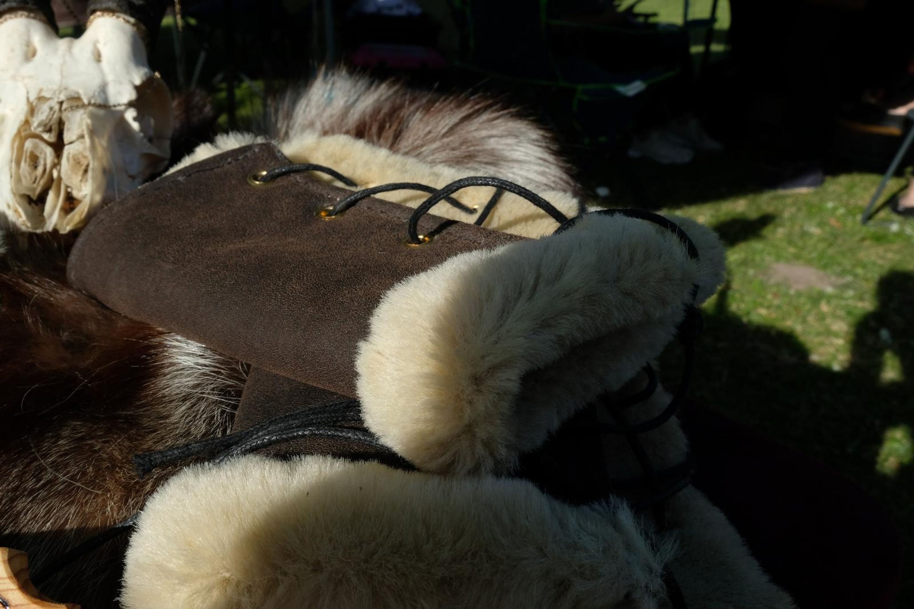 Close-up of a brown leather arm wrap lined with cream sheepskin