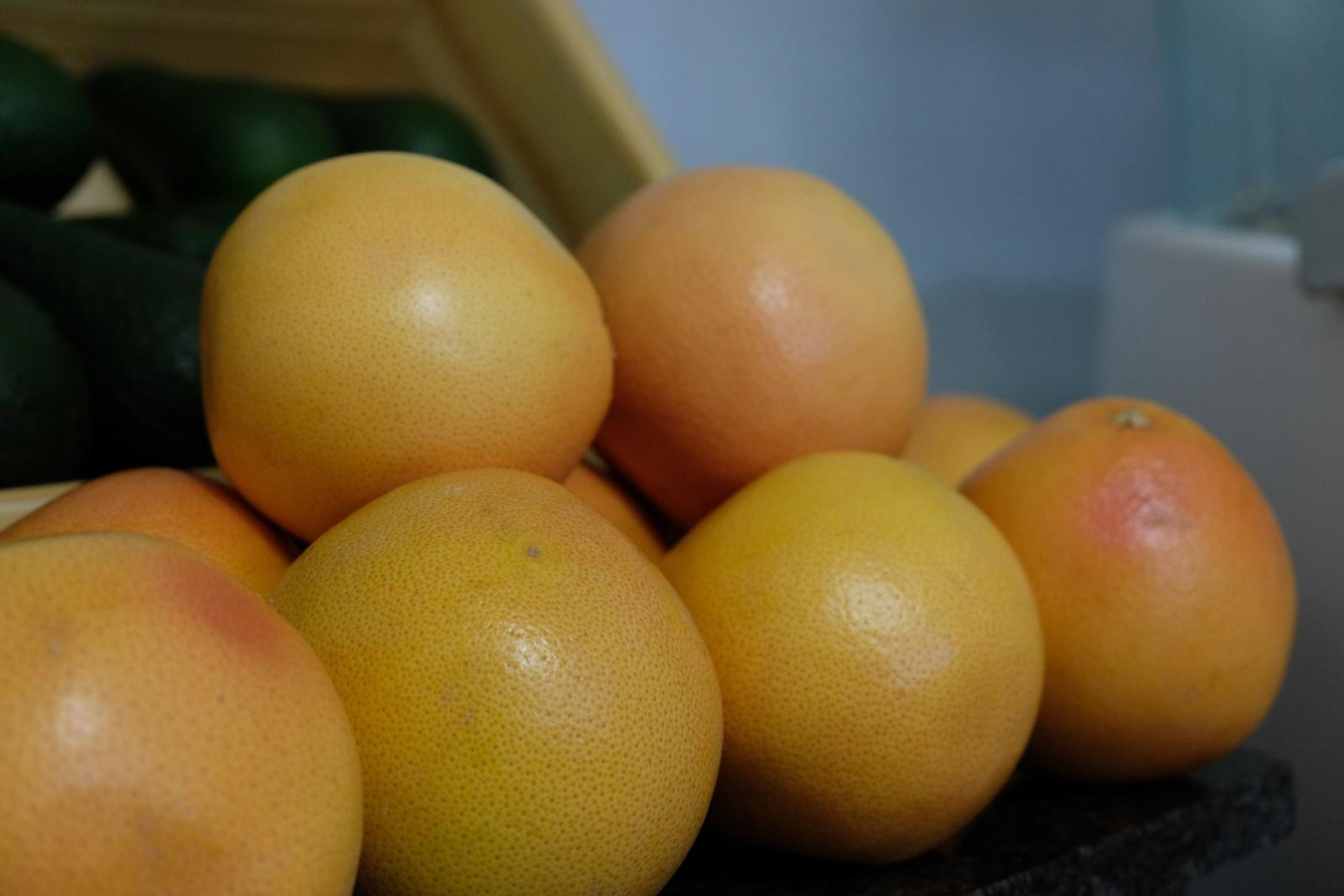 Grapefruit and oranges stacked in a crate